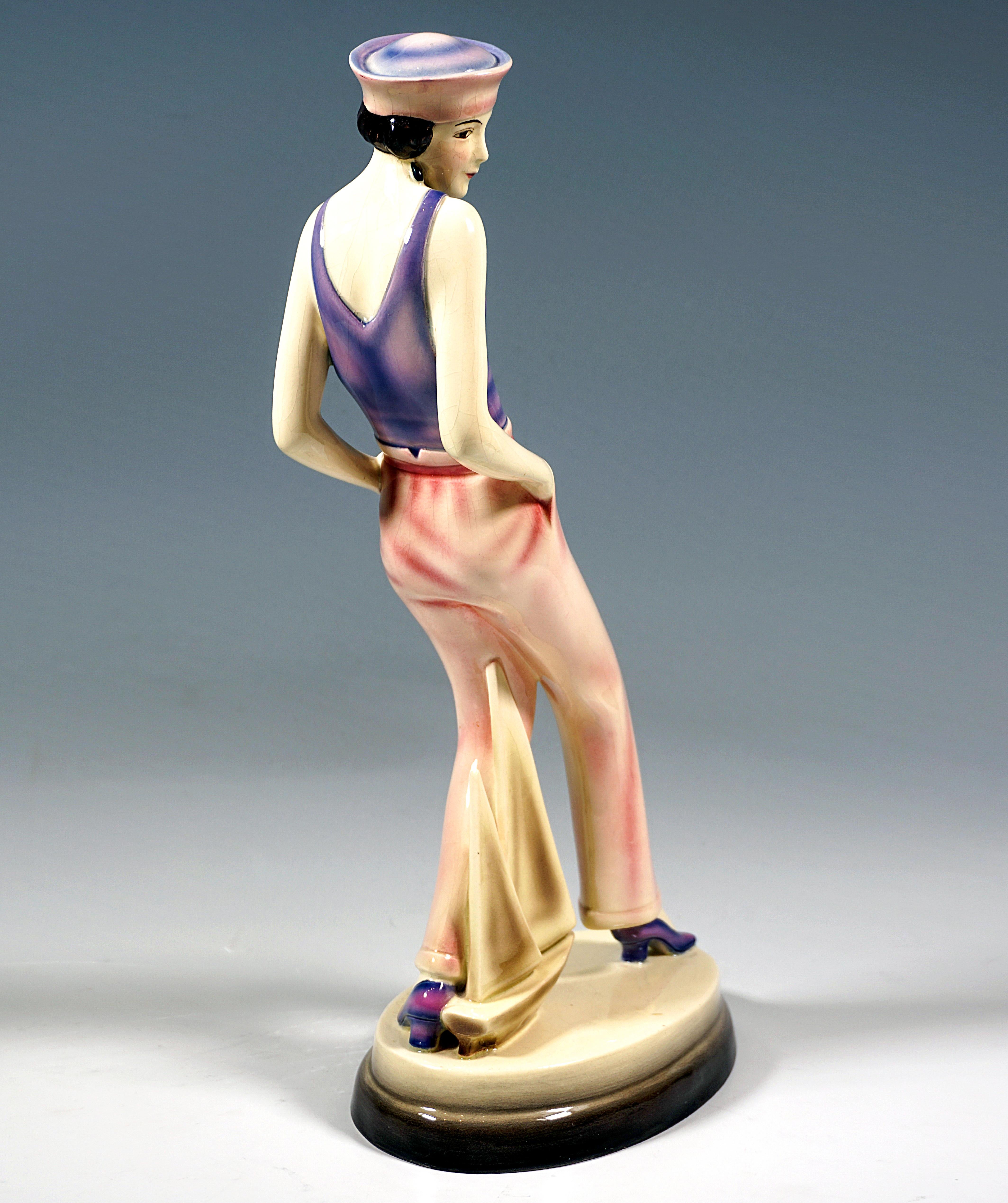 Very Rare Art Déco Goldscheider Ceramics Figurine around 1930:
Young dancer in a sleeveless top reminiscent of a bathing suit and wide trousers, a sailor hat on the short black curls, looking to the right and taking a step forward with her right
