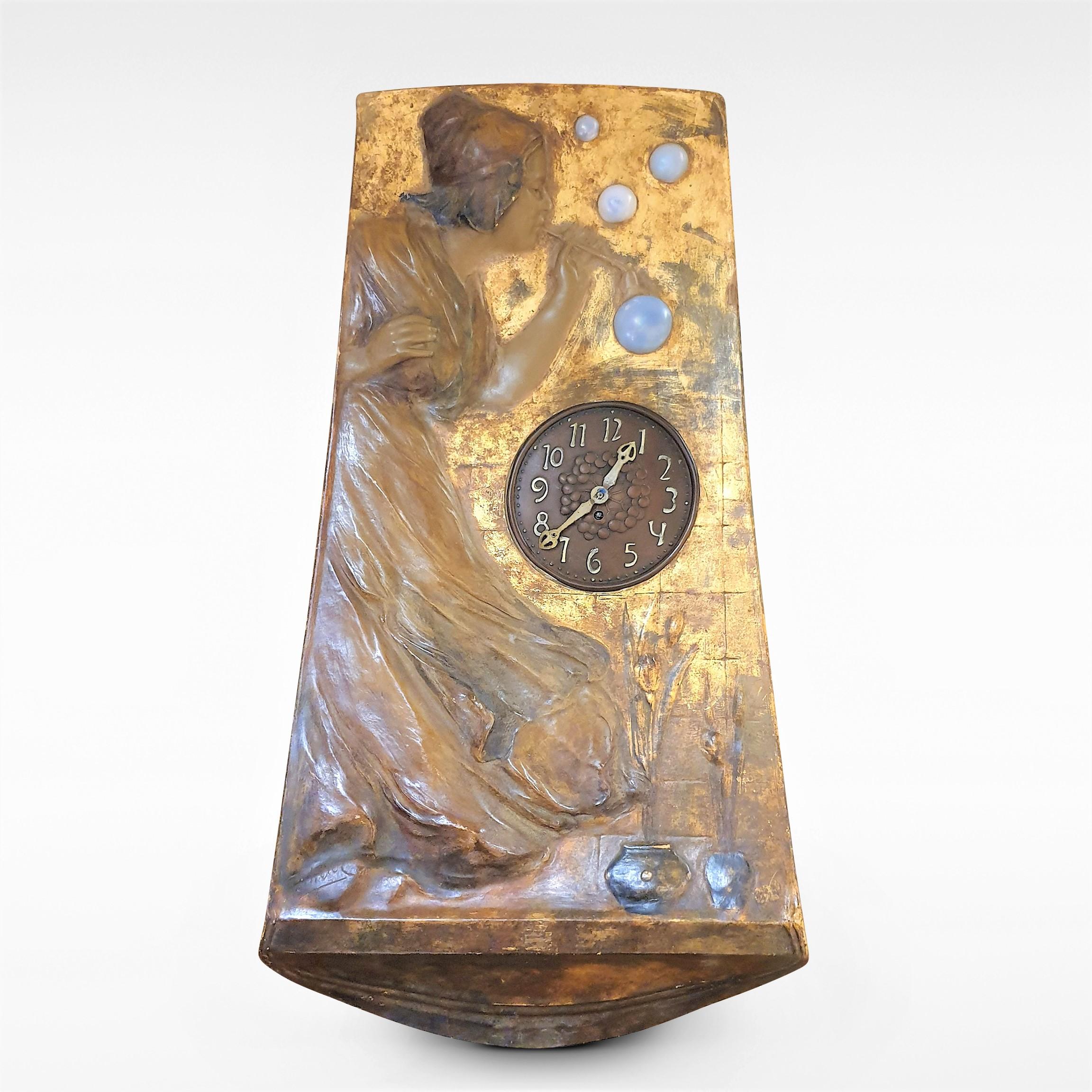 This a rare Art Nouveau wall clock by Goldscheider with a young woman blowing bubbles. Gilt ceramic and bronze, made in Vienna, circa 1900. Full maker’s marks to the top, and signed ‘Pecheur’ to front lower left. Clock movement fully serviced.