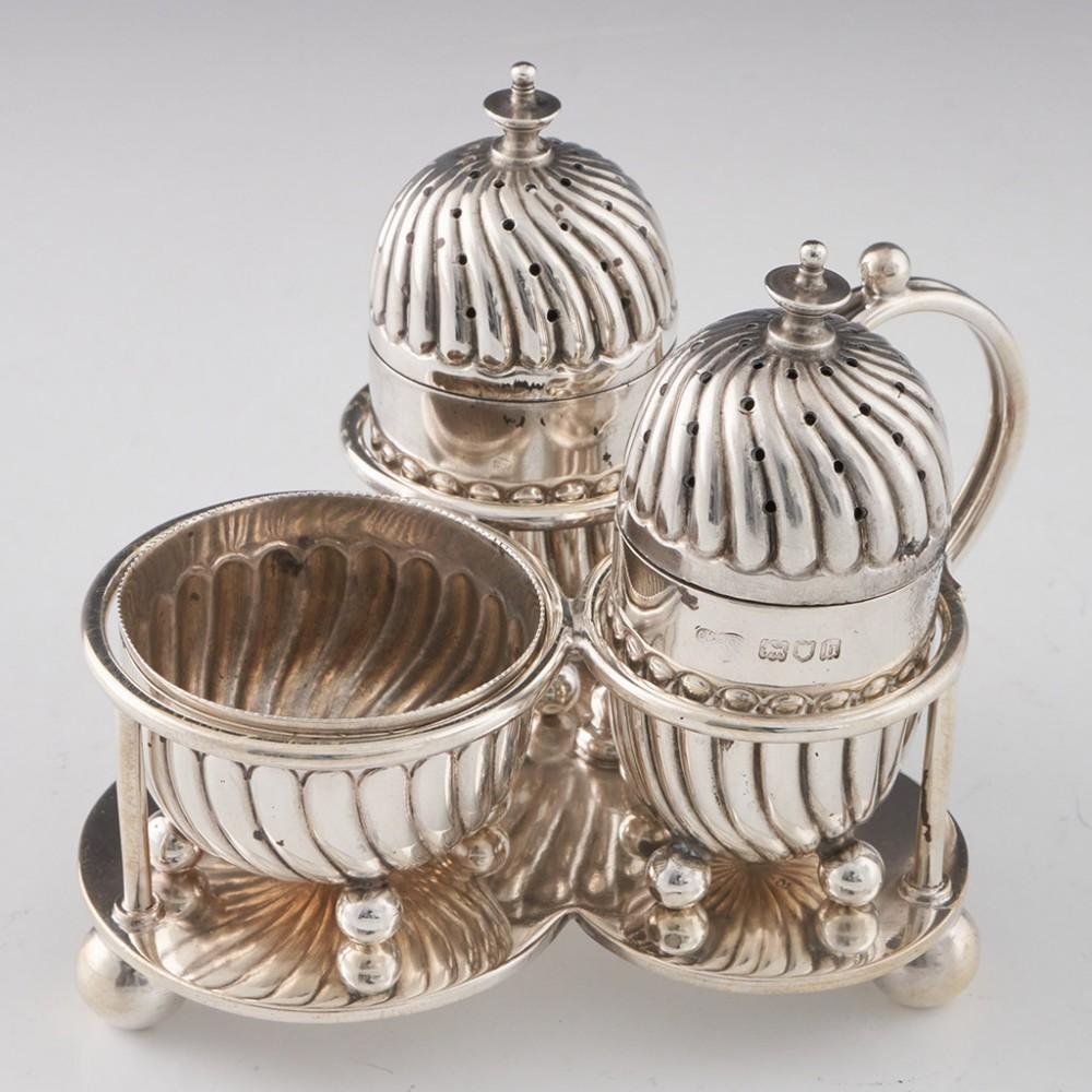Heading : Goldsmiths and Silversmiths cruet set
Date : Hallmarked in London in 1903 for the Goldsmiths and Silversmiths company
Period : Edward VII
Origin : London, England
Decoration : Features salt, pepper, and mustart pots. Each piece with