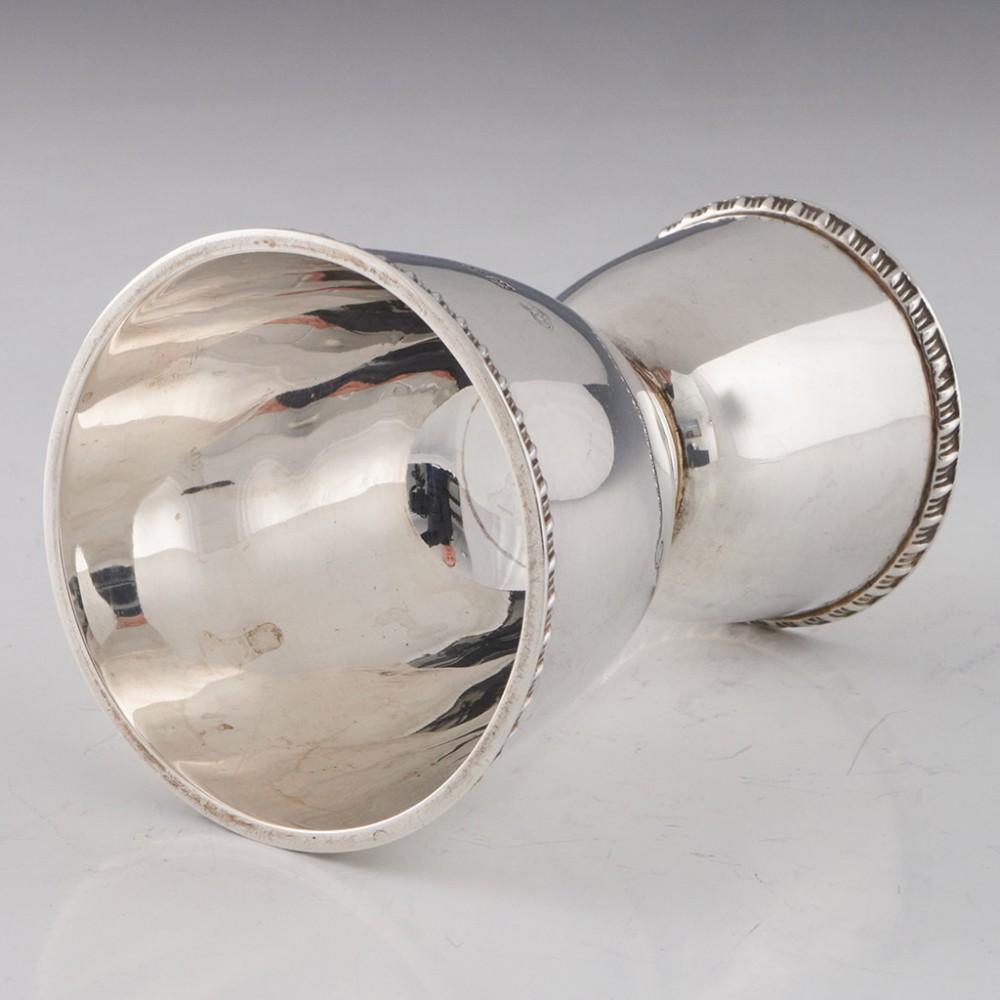 Heading : Goldsmiths and silversmiths jigger
Date : Hallmarked in London in 1933 for the Goldsmiths and Silversmiths Company
Period : George V
Origin : London England
Decoration : Both measures are of round funnel form with pie crust rims
Size : 