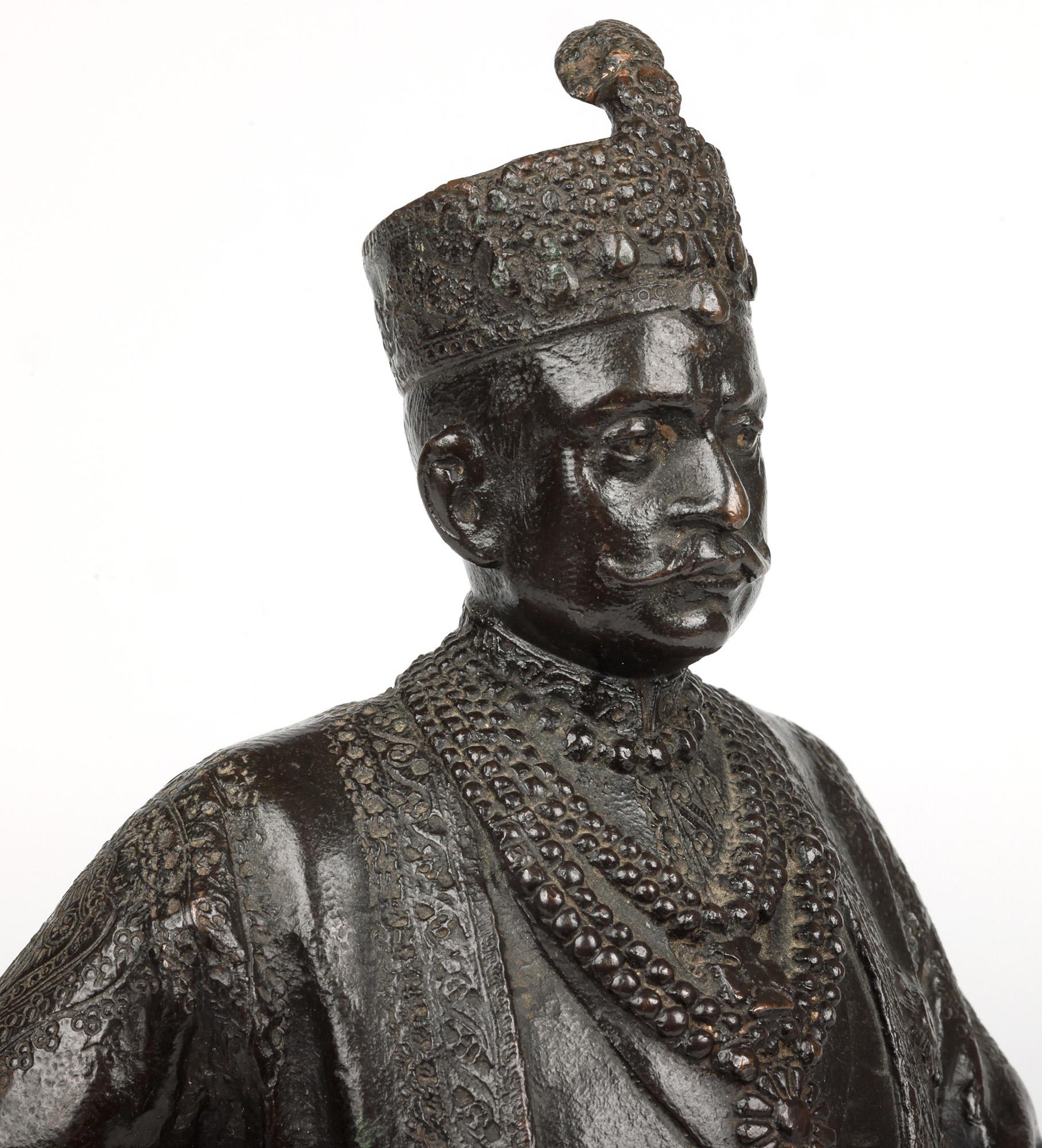 A superb quality antique bronze sculpture of a Middle Eastern gentleman in regal dress by the renowned Goldsmiths & Silversmiths Company, London dating from around 1900. The well cast figure stands raised on a square base and is dressed in a knee