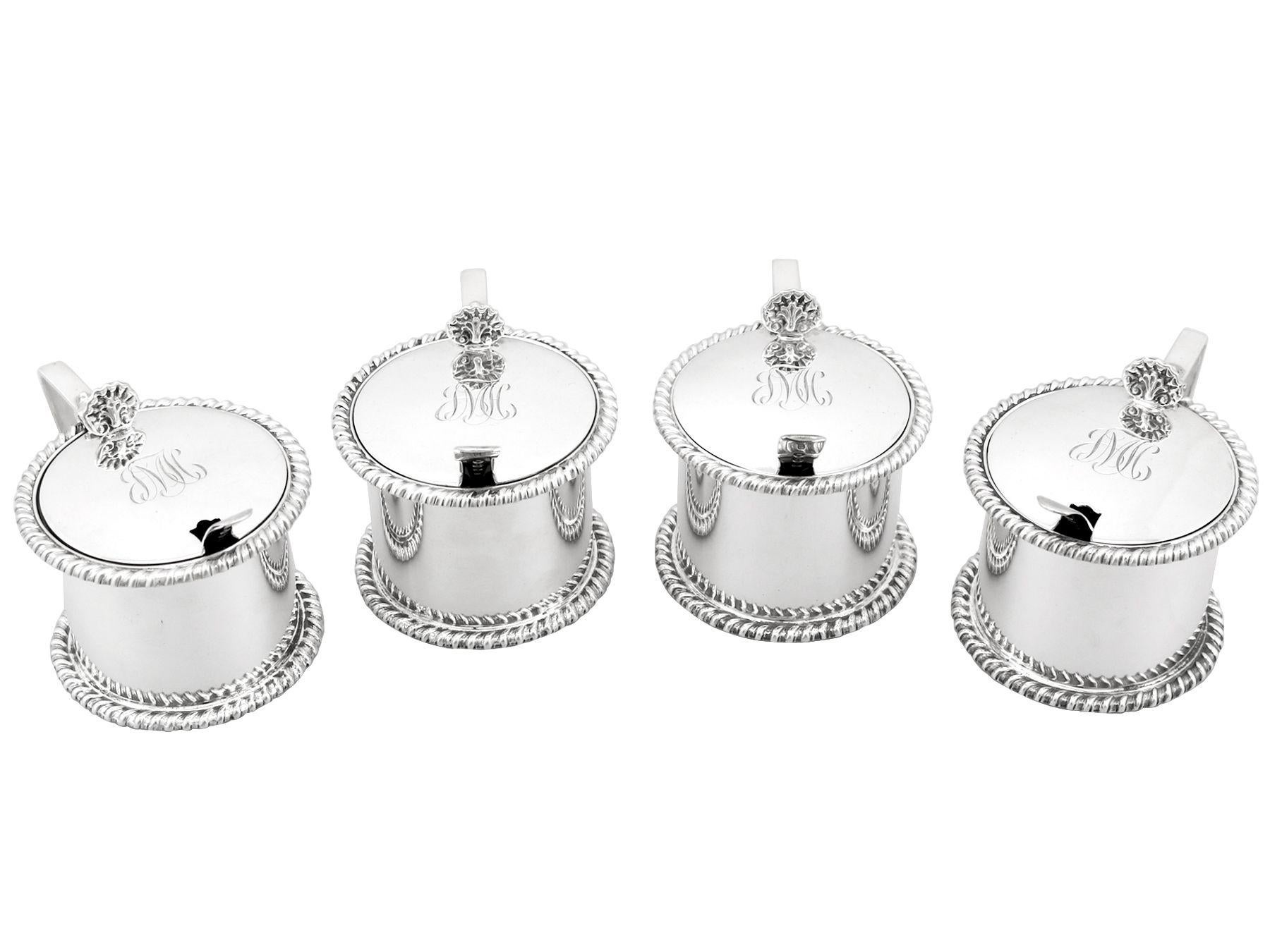 An exceptional, fine and impressive composite set of four antique George V English sterling silver drum mustard pots; an addition to our silver cruet and condiments collection.

These exceptional antique George V sterling silver mustard pots have a