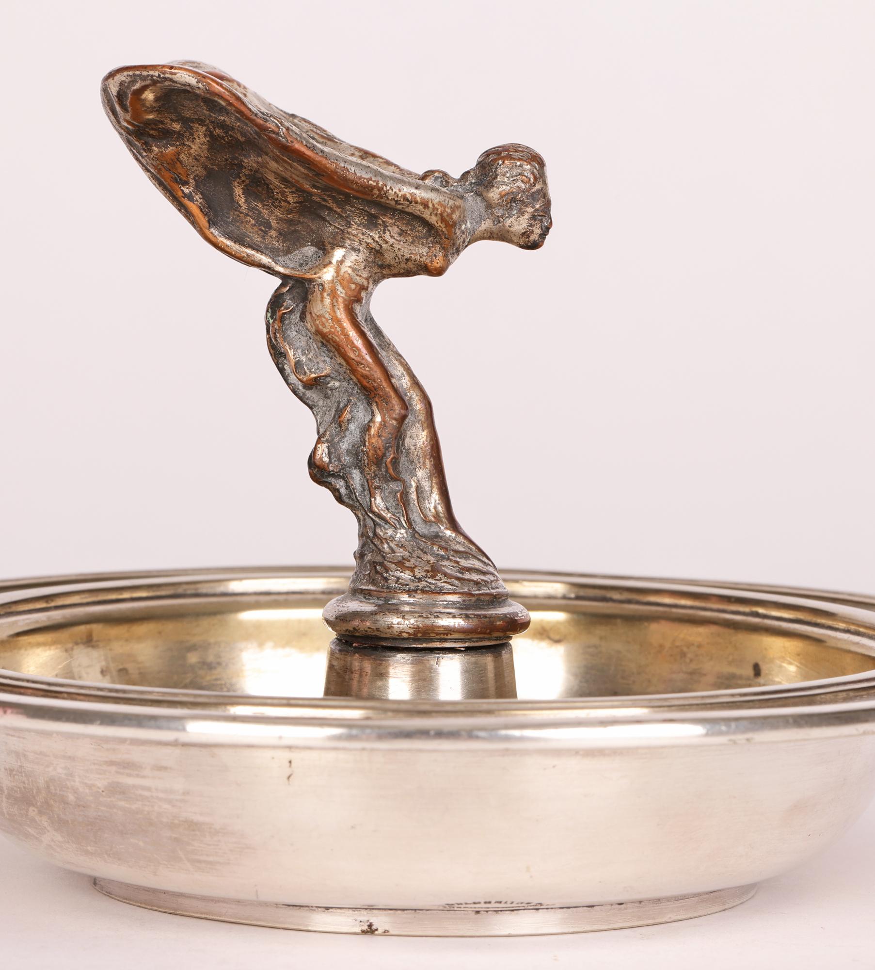 A rare and unusual Goldsmiths & Silversmiths Company, London silver plated Rolls Royce presentation dish mounted centrally with the Spirit of Ecstasy and dating from around 1915. This good quality dish, possibly intended as an ashtray, is heavily