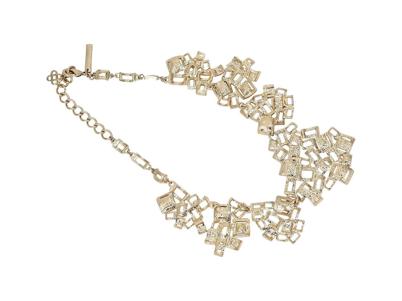 Product details:  Goldtone statement necklace by Oscar de la Renta.  Accented with crystals.  Adjustable clasp closure.  17.5