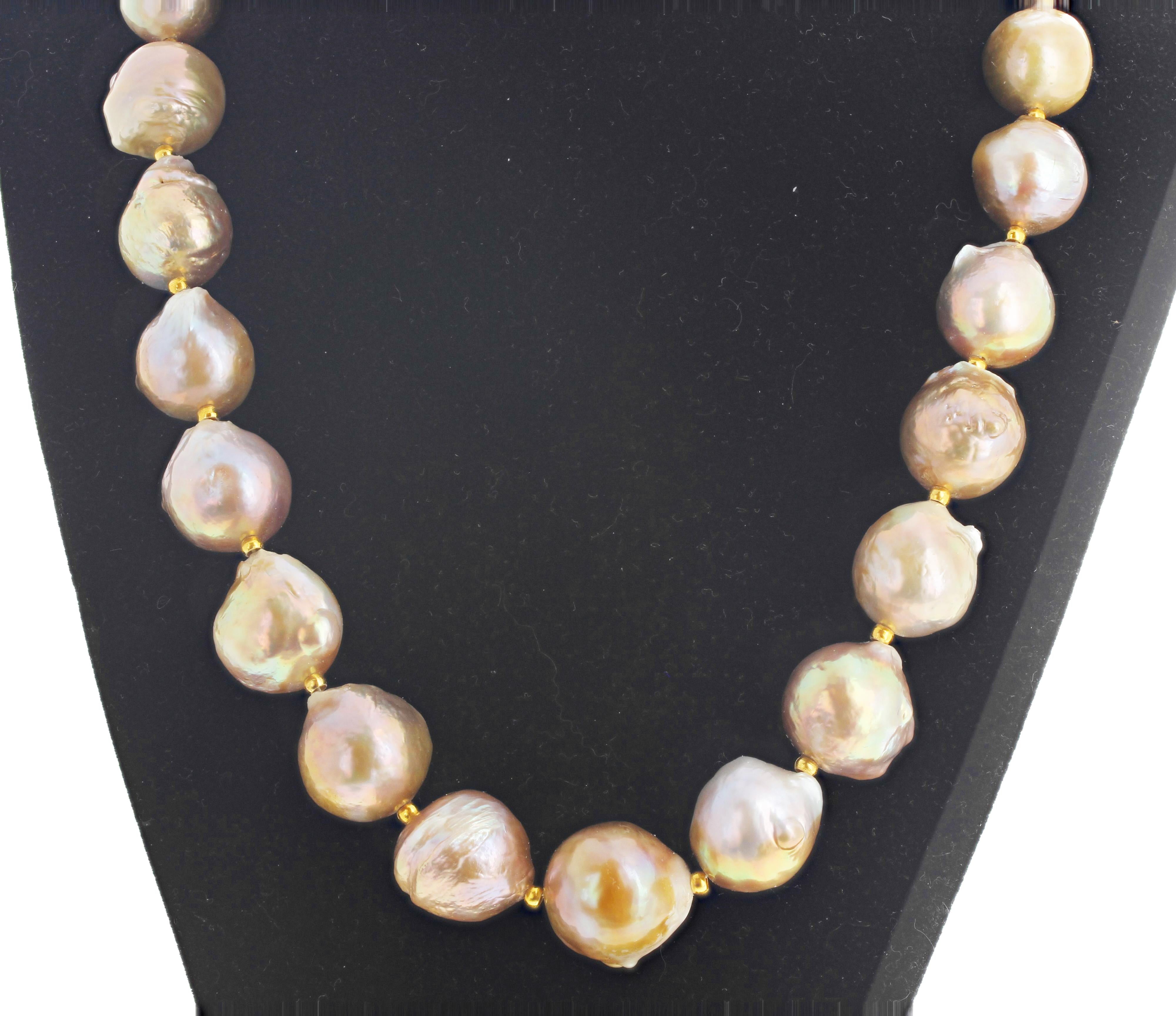Brightly glowing brilliant goldy ocean cultured pearls ( averaging 18mm round approximately ) set in a 17 inch long necklace with gold plated clasp. Click through the pictures of this to see how magnificent the different natural colors are.  