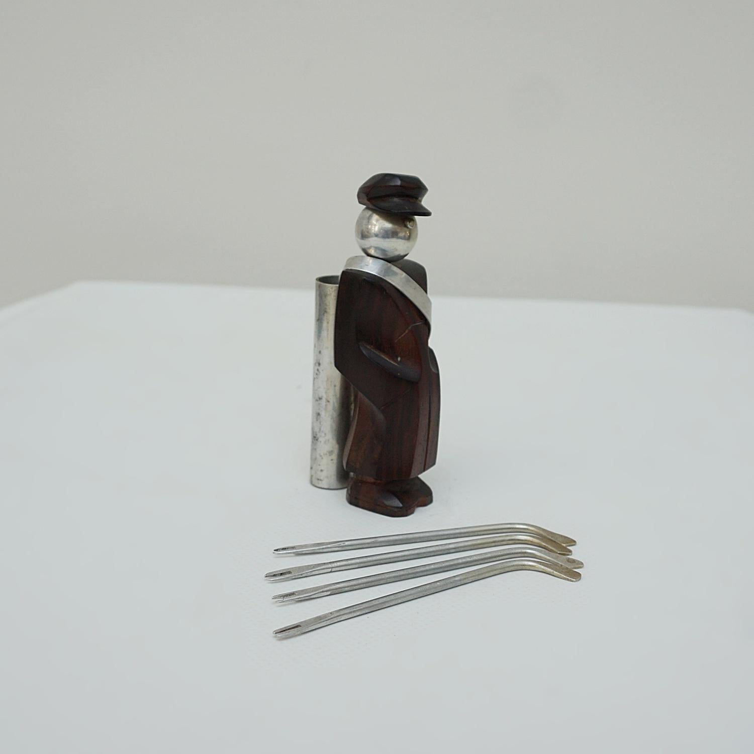 An Art Deco golf caddie cocktail pick holder. Macassar ebony and metal, stamped 'made in France' to underside.

Dimensions: H 11cm W 3.5cm D 5 cm

Origin: France 

Date: Circa 1930's

Item Number: 1006234.