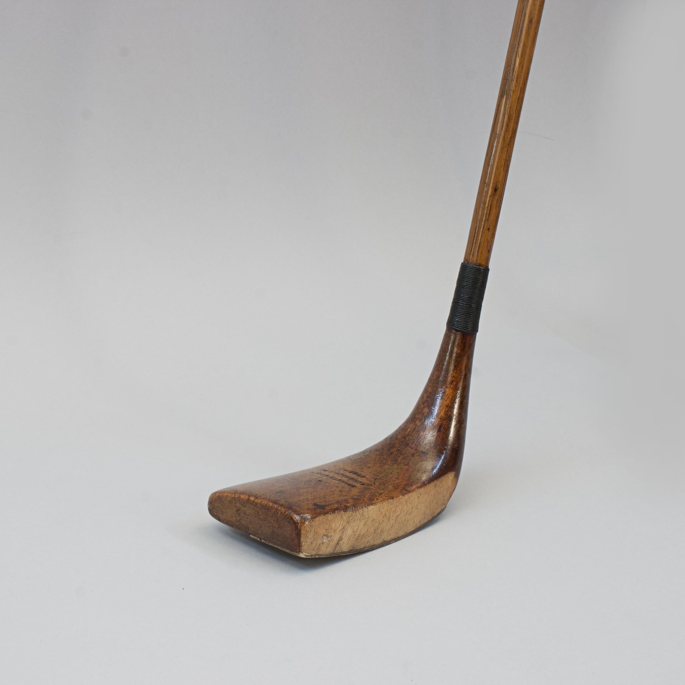 Antique Gassiat Style Putter, Ernest F. Sales, Sunningdale.
A good example of a hickory shafted persimmon wood 'Jean Gassiat' type putter with a polished leather 'pistol grip'. The makers name is stamped on the crown of the club 'Ernest F. Sales,