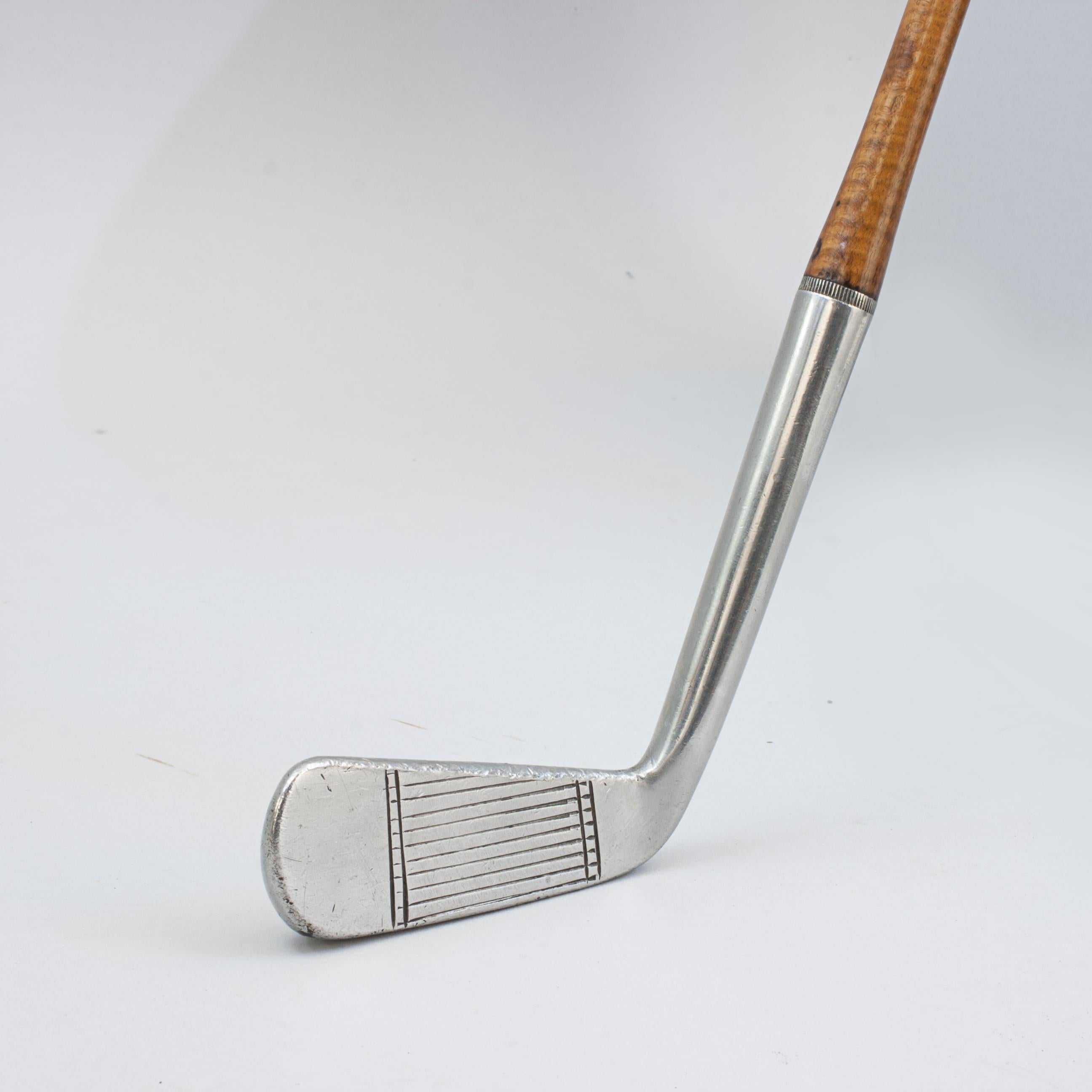 Walter Hagen Ambassador Putter.
A good usable blade putter by Walter Hagen with a Danga wood shaft and pistol grip. The stainless steel putter has good line markings and is stamped with a 'crown' with 'Walter Hagen, Ambassador'. There is also a