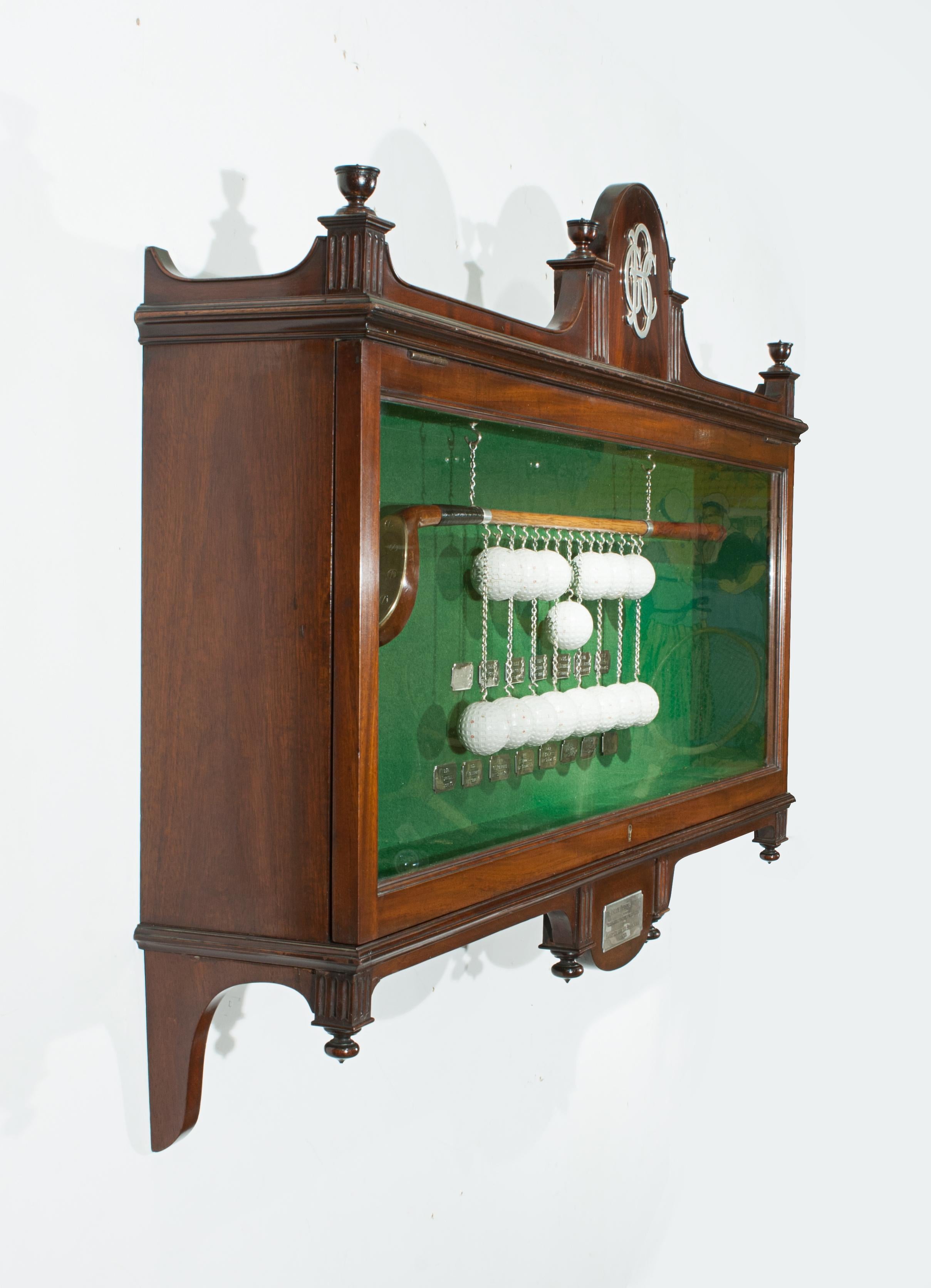 Beckenham Golf Club trophy cabinet.
An early 20th century wall-mounted trophy display case made for Beckenham Golf Club by their professional Harry Brown. The cabinet bears a silver-plate monogram of 'BGC' for Beckenham Golf Club. There is a model