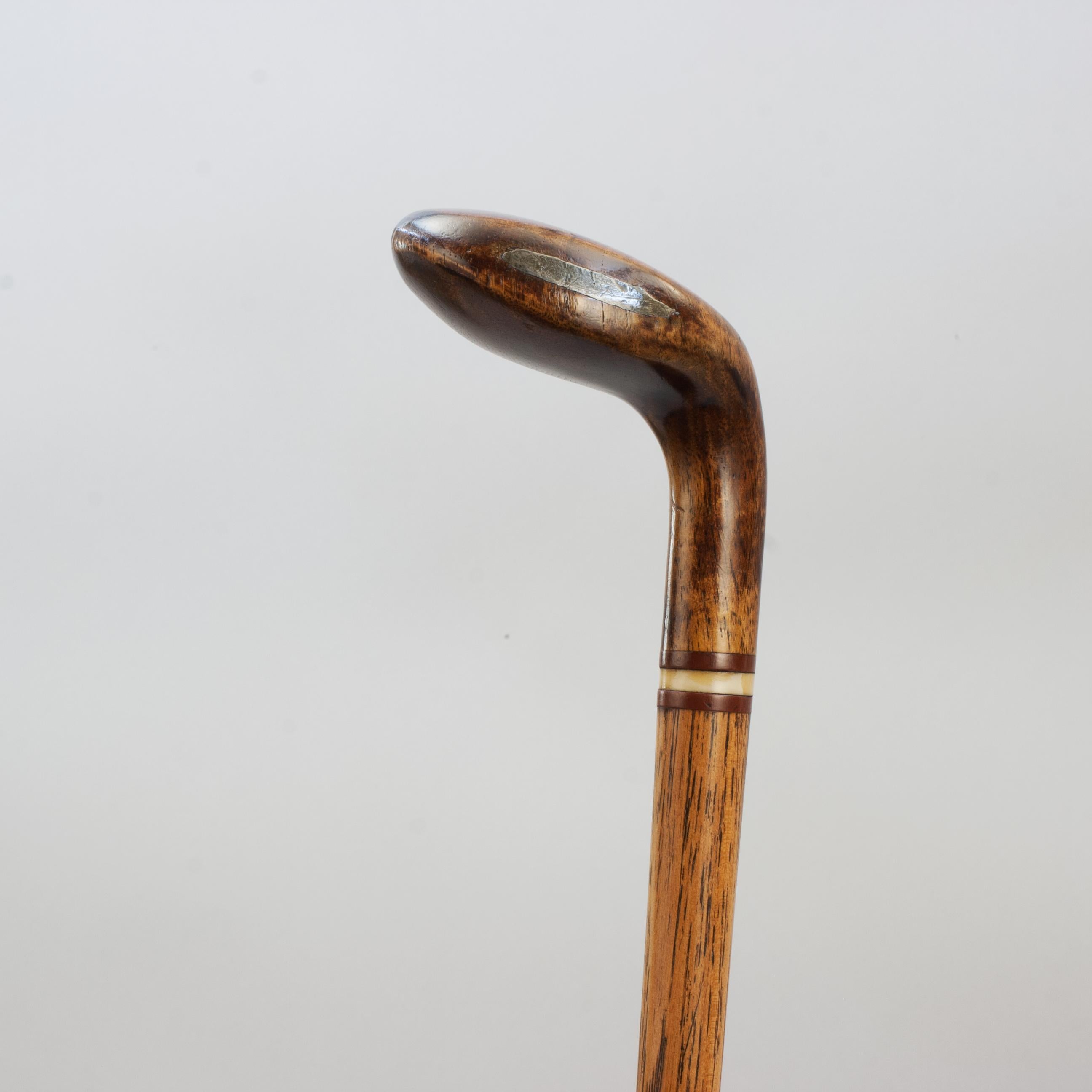 Antique Sunday Club, Golf Club Walking Stick.
A desirable walking cane with the handle in the shape of a golf club head. The gentleman's walking stick has a persimmon socket head handle with a curved soled with pegged horn insert, face insert with