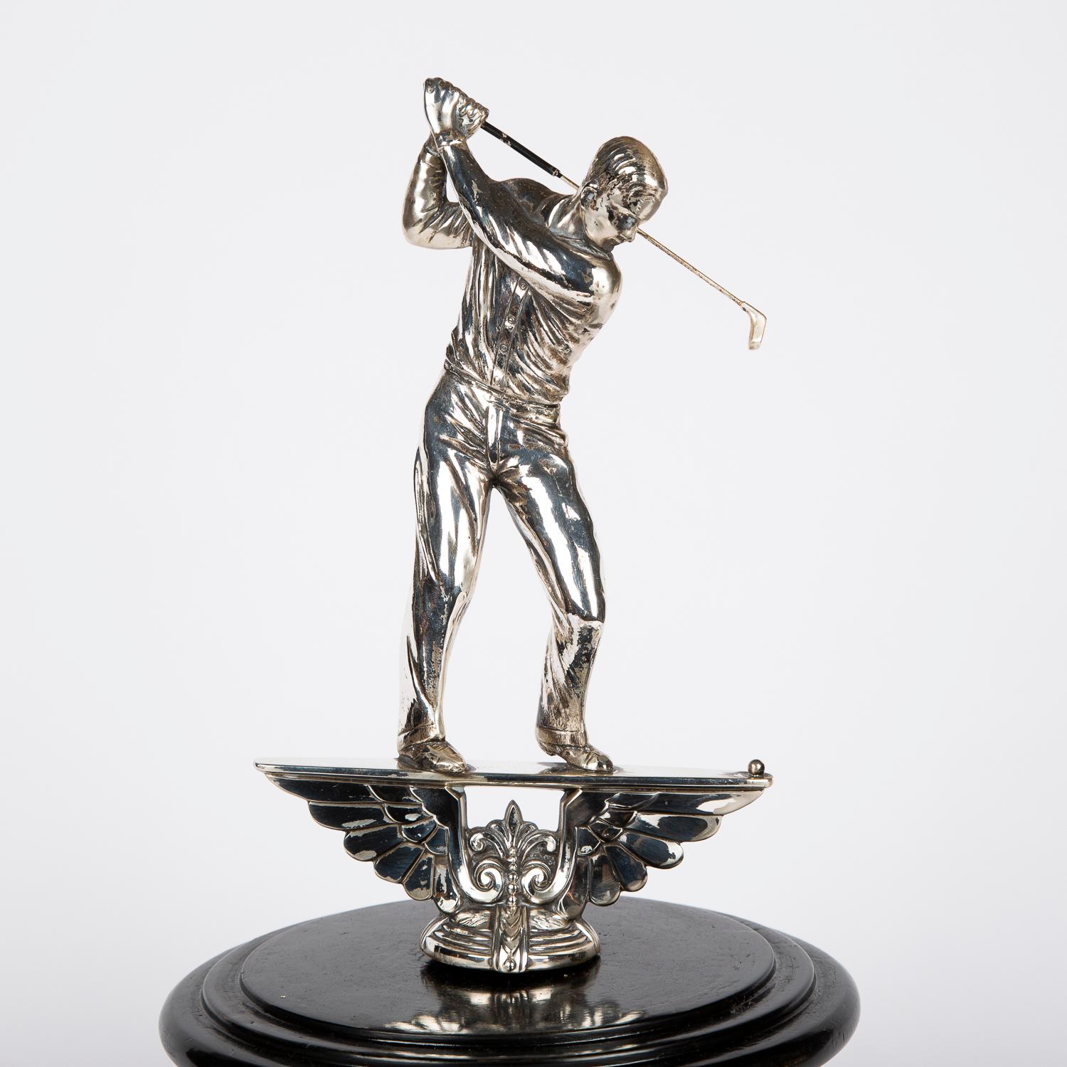 A golf trophy with a nickel-plated golfer teeing off with a driver on a turned ebonized base.
