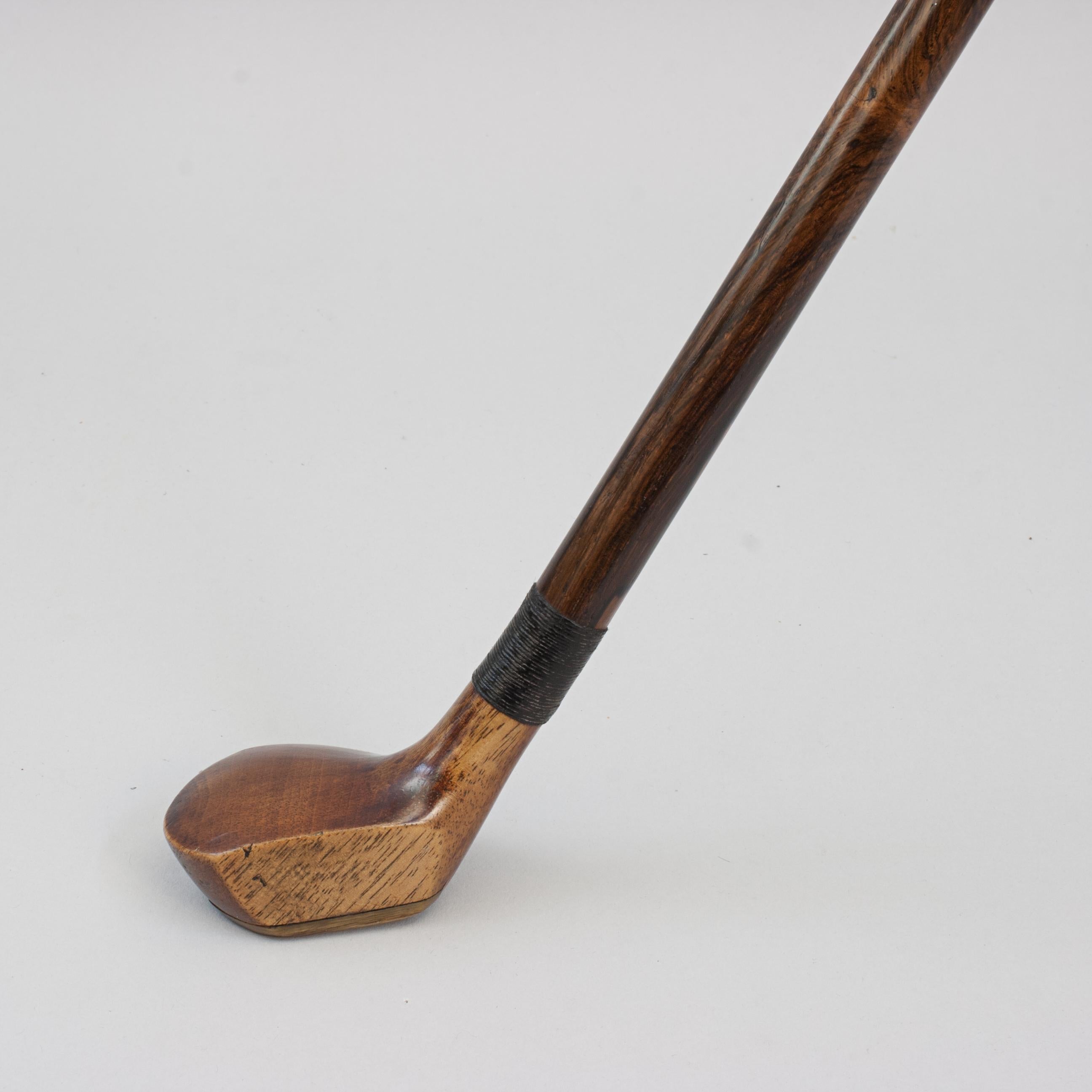Antique Sunday Club, Golf Club Walking Stick.
A desirable walking cane with the handle in the shape of a golf club head. The gentleman's walking stick has a small persimmon socket head handle with a pegged horn insert and a lead weight to the rear.