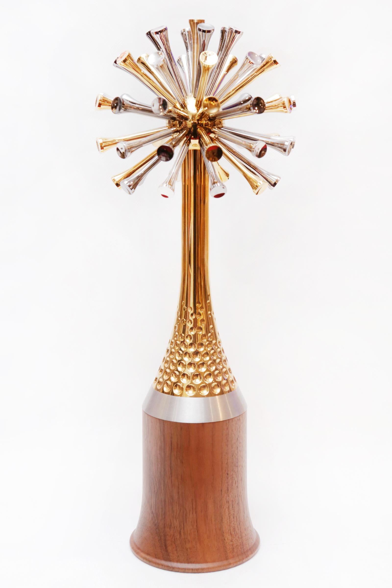 Sculpture Golfer Trophee with solid walnut base and with
50 tees in 3 finishes: Gold, palladium and ruthenium. With
customizable personal small plate on the base with name 
or short words. Exceptional piece.