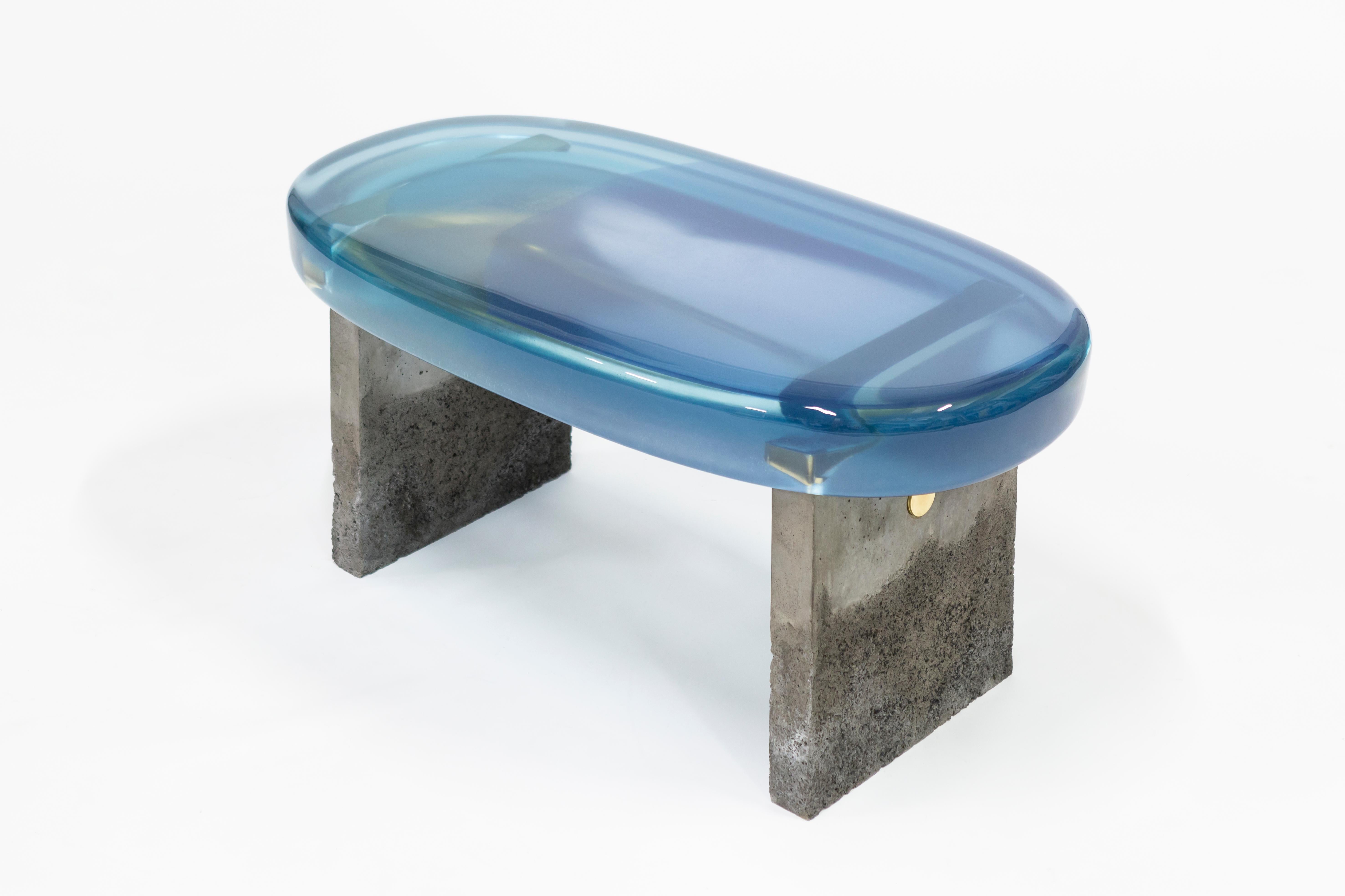 Golia bench by Draga & Aurel
Dimensions: W 67 x D 33 x H 44 cm
 top Ø 50 x 96 cm
Materials: Resin top, concrete

The Golia benches are featured by sculptural, almost monumental forms, and by
an unusual combination of material: The raw, solid