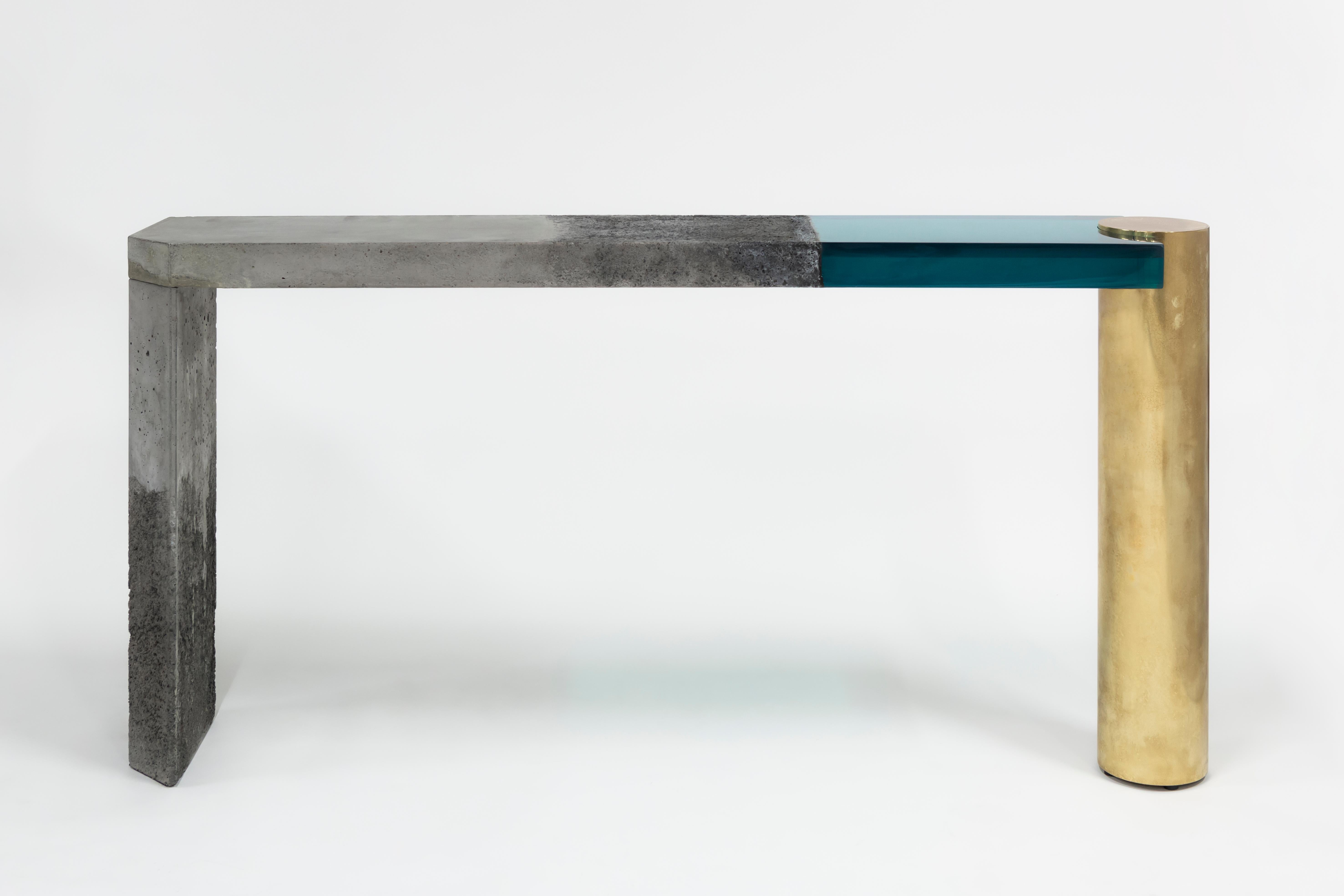 Golia console by Draga & Aurel.
Dimensions: W 169 x D 30 x H 85 cm
Materials: Resin, Concrete, Etched brass.


The Golia consoles are featured by sculptural, almost monumental forms, and by an unusual combination of material: The raw, solid