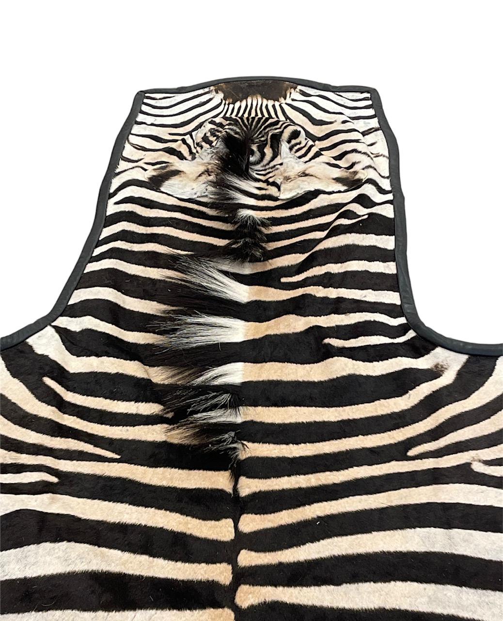 Modern Gomez Zebra Hide Rug Trimmed in Black Italian Leather For Sale