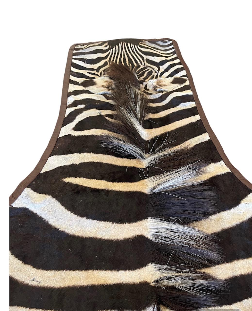 Modern Gomez Zebra Hide Rug Trimmed in Brown Italian Leather For Sale