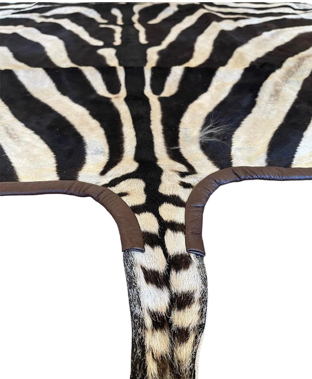 American Gomez Zebra Hide Rug Trimmed in Brown Italian Leather For Sale