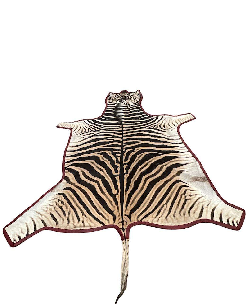 Contemporary Gomez Zebra Hide Rug Trimmed in Burgundy Leather For Sale