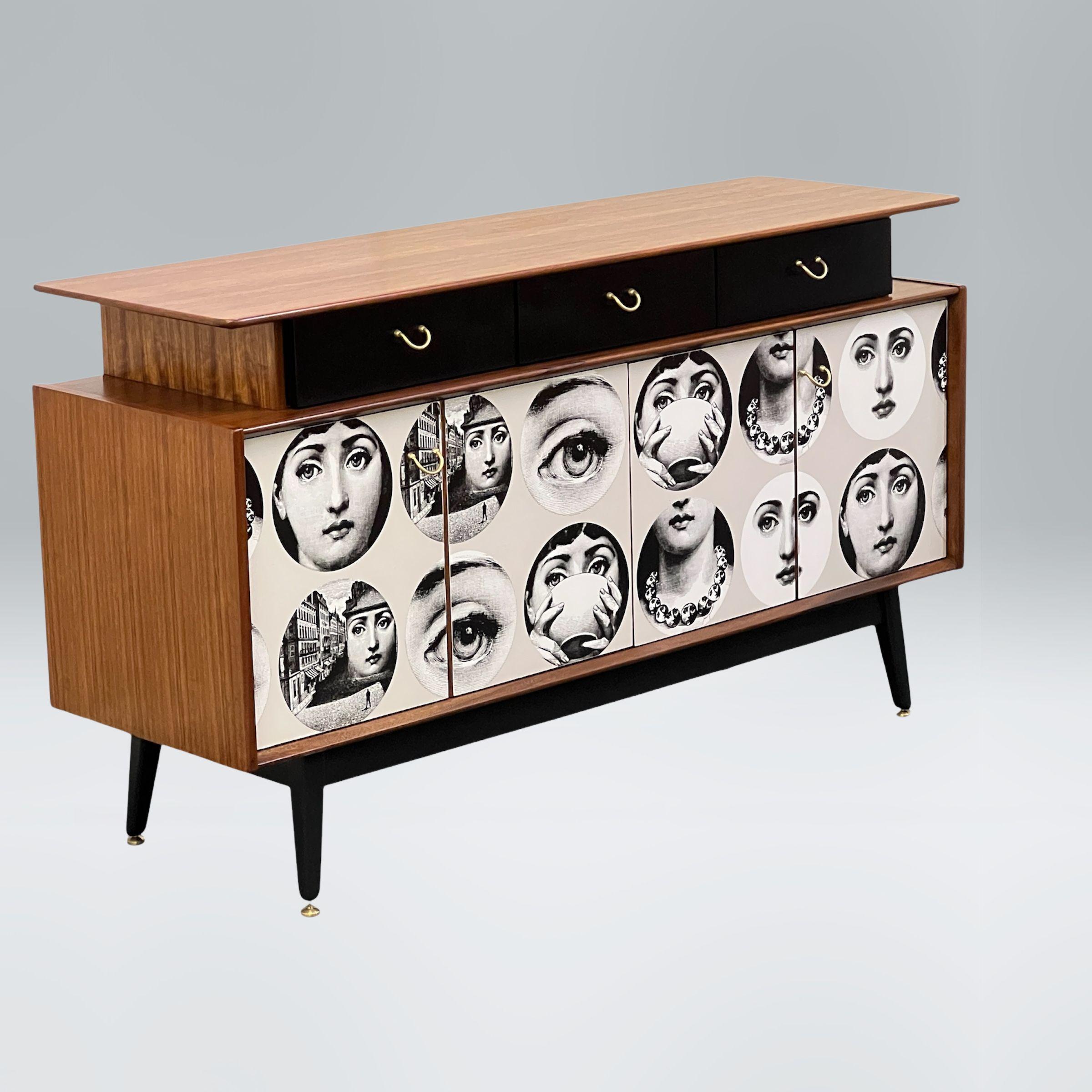 A beautifully crafted teak sideboard by E Gomme from 1958. Creatively decoupaged with a Fornasetti’s wallpaper of the famous Italian operatic soprano, actress, and monologist Natalina “Lina” Cavalieri (1874–1944). The sideboard has been sanded back