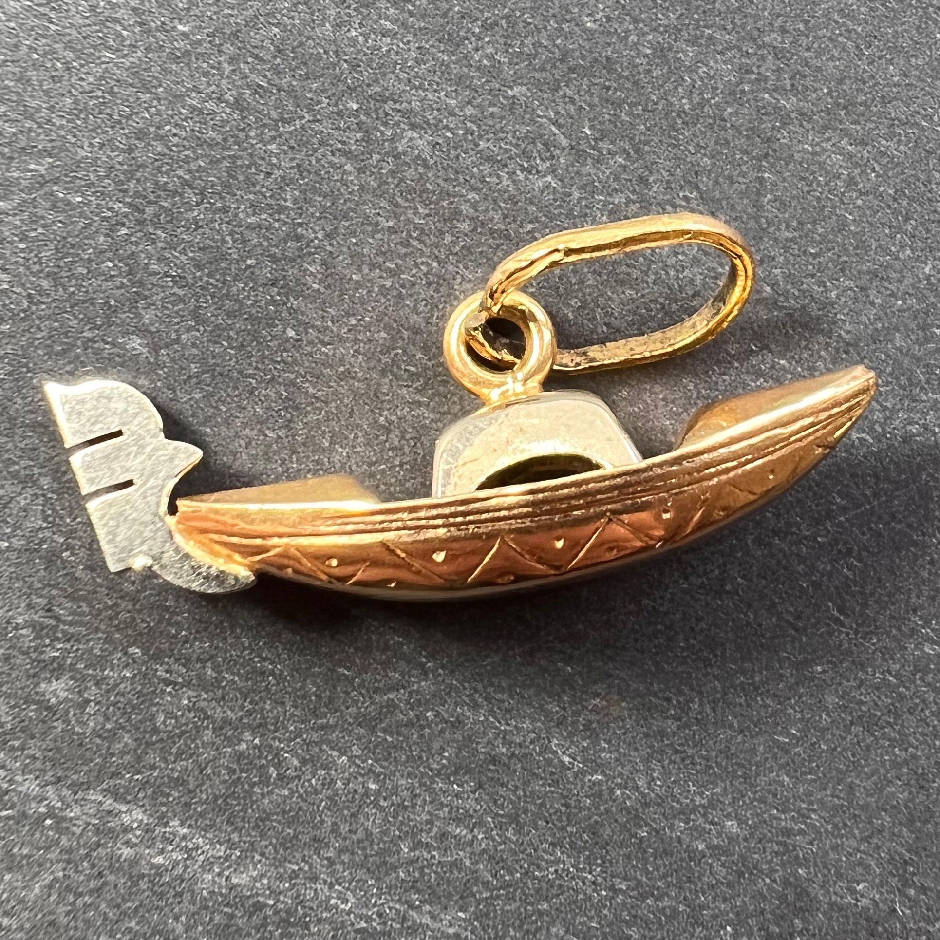 An 18 karat (18K) yellow gold charm pendant designed as a gondola with white gold detail. Unmarked but tested for 18 karat gold.
 
Dimensions: 1 x 2.6 x 0.6 cm (not including jump ring)
Weight: 1.52 grams
 (Chain not included)