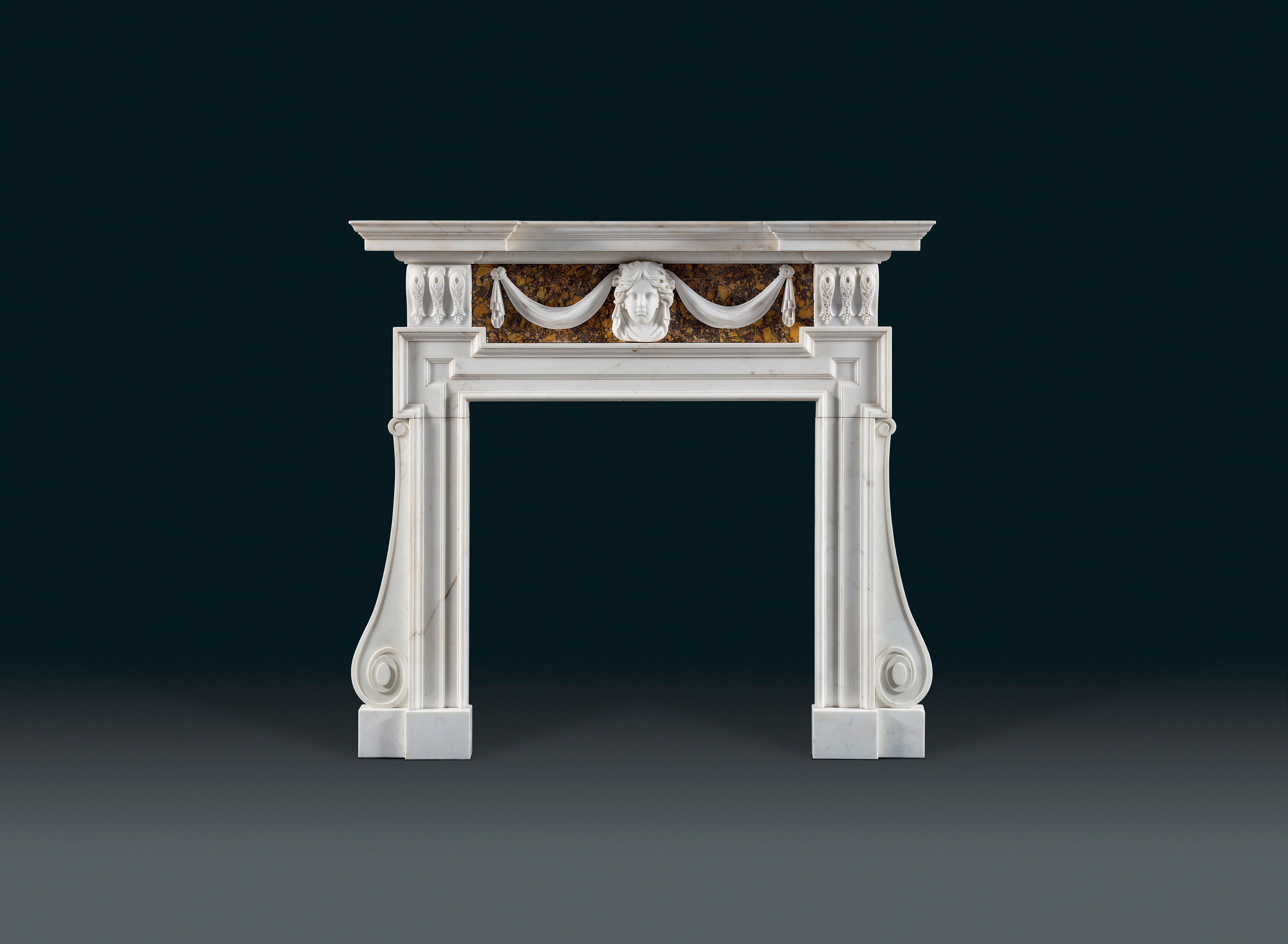 A good 18th century Palladian fireplace in statuary and Siena marbles after an original design by Inigo Jones, adapted by William Kent or one his disciples, possibly John Vardy, circa 1740-1745. 
 
The stepped and moulded breakfront shelf above an