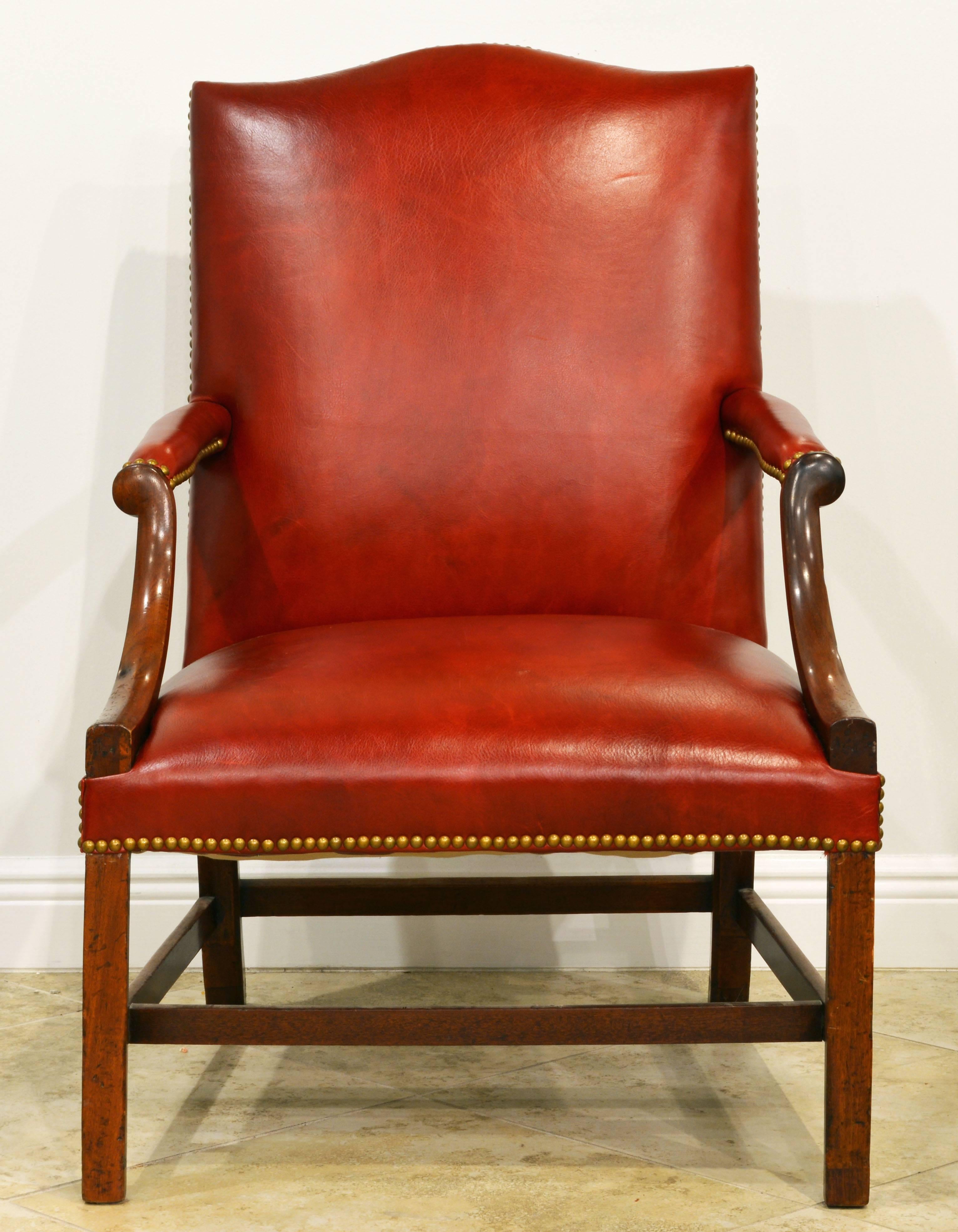 Newly recovered in high quality red leather this classic and comfortable English lolling chair makes a handsome impression very suitable for a library setting or a gentleman's corner.