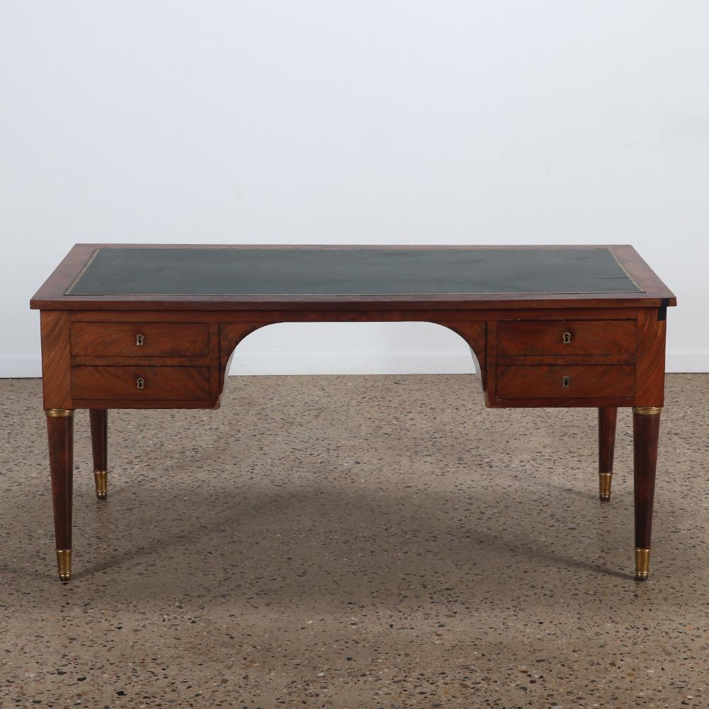 Good French crotch mahogany late 19th Century leather top desk having round legs with bronze mounts. This desk is finished on the backside. 
Kneehole measurements: 25.5