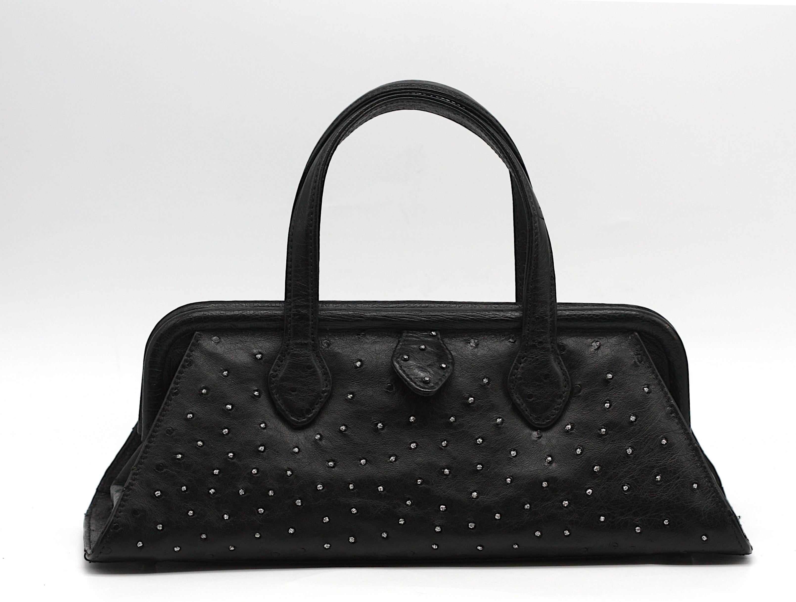 Lana Marks “Diamond Dust” Black Ostrich Handbag
Of refined contemporary elegance, this structured handbag by Lana Marks is fashioned from supple black ostrich. The shaped body presents a striking contrast, with one side adorned in shimmering