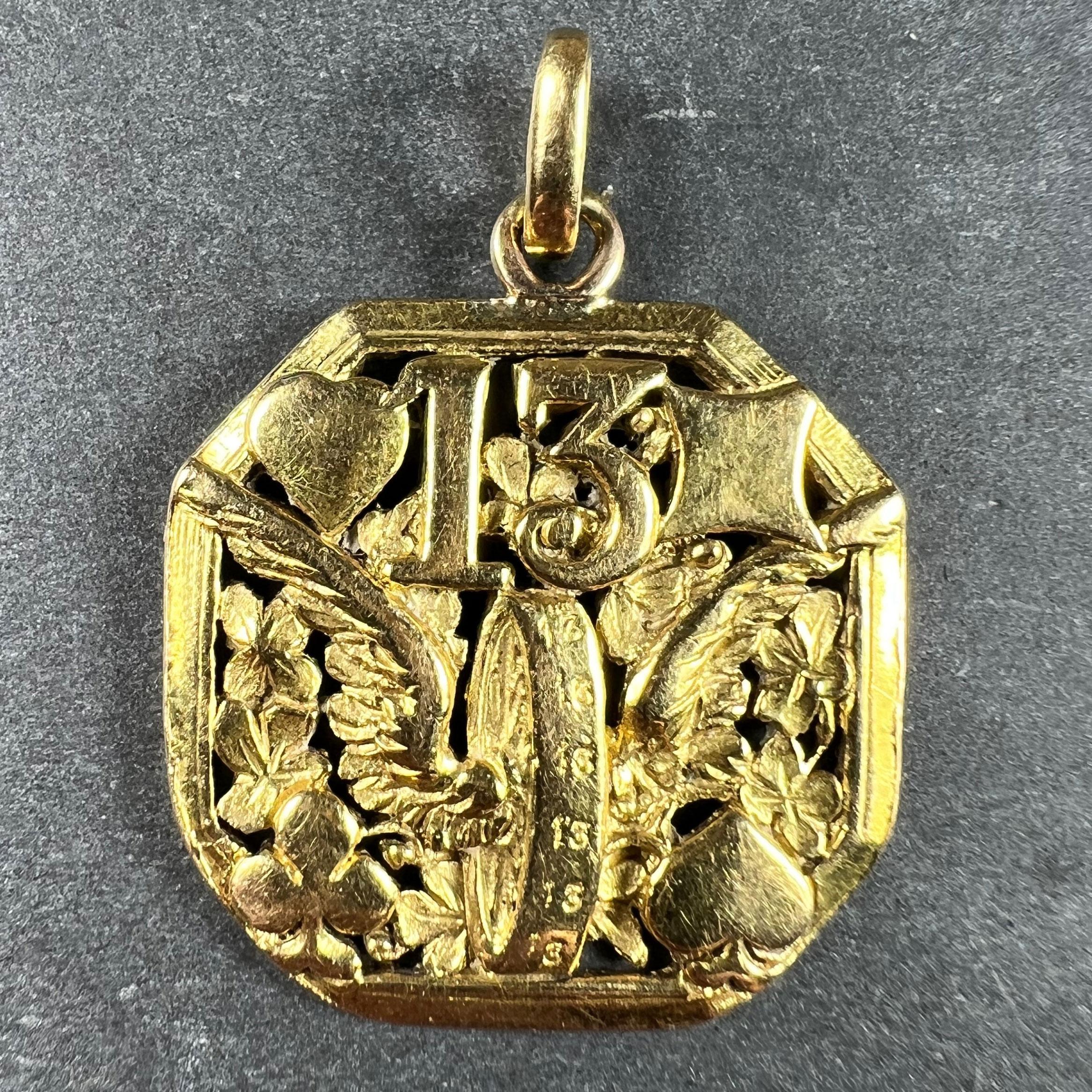 An extraordinary, large French 18 karat (18K) yellow gold lucky charm pendant designed as a pierced octahedron with multiple symbols for good luck, centring on the winged wheel of Hermes, which has the number 13 engraved multiple times on the tread