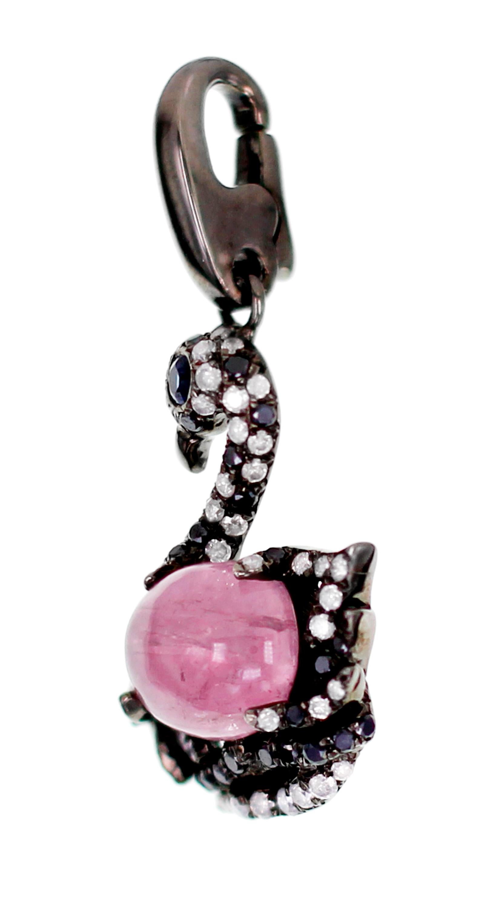 A rare 2.37 carat of Afghan Pink Tourmaline is set with Sapphires, White brilliant round diamond and Black diamond. Did you know the swan is a symbolism of motherhood? Yep. They are also symbolic of love, devotion and partnership.