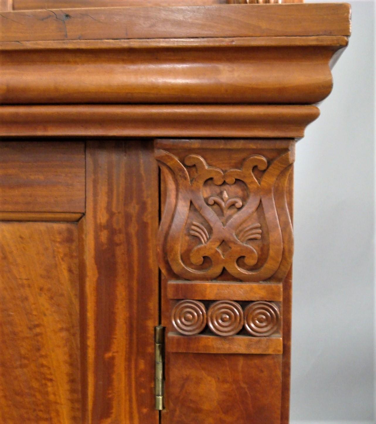 Good mid-19th century Anglo-Indian solid satinwood chiffonier of stylish and bold proportions; the raised superstructure having a panelled back with the shelf on carved turned supports with a brass fixing to the top; and matching half pillasters to