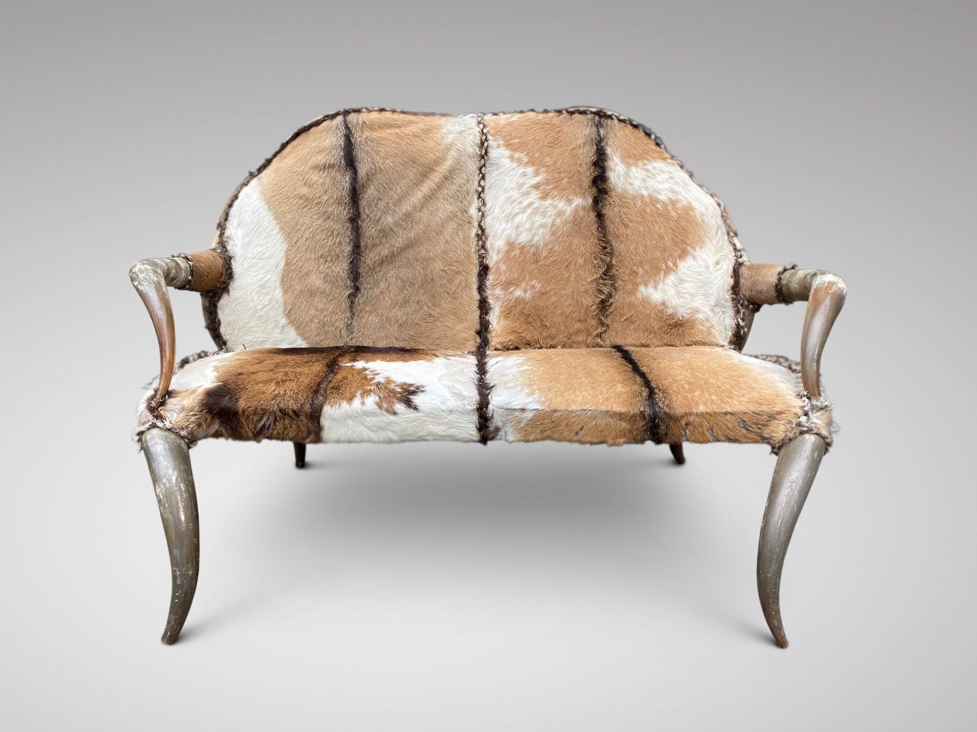 A very decorative and in good condition late 19th century 8 horn 2 seater sofa with original upholstery. The back and arms fashioned with horns as well as the feet. The seat is covered in the original hide. Toward the end of the 19th century, there