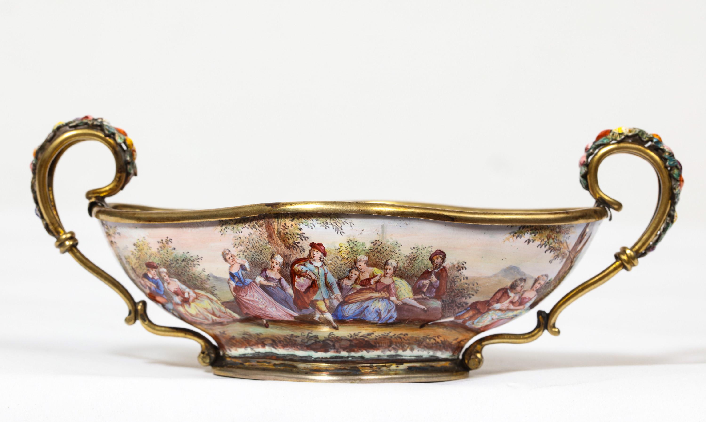 Good Quality Antique Silver-Mounted Viennese Enamel Bowl, by Hermann Ratzersdorfer, circa 1870

Finley hand painted throughout with figural and romantic scenes, the handles enameled with fruits and flowers.

Hallmarked throughout.

Marked HR for