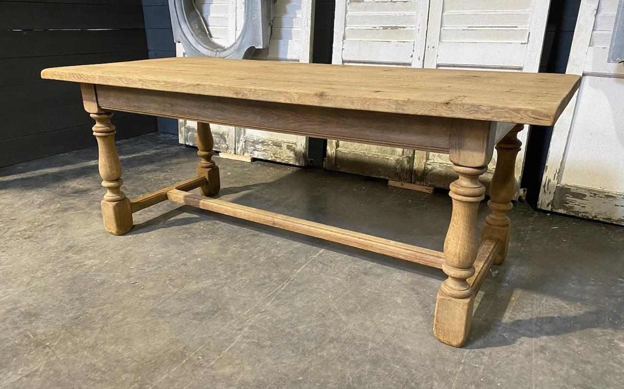 A good quality solid oak farmhouse dining table. French in origin and dating to the early 1900s. This table is of excellent quality construction and will be around for generations to come.
We have lightly bleached it to bring out the beauty of the