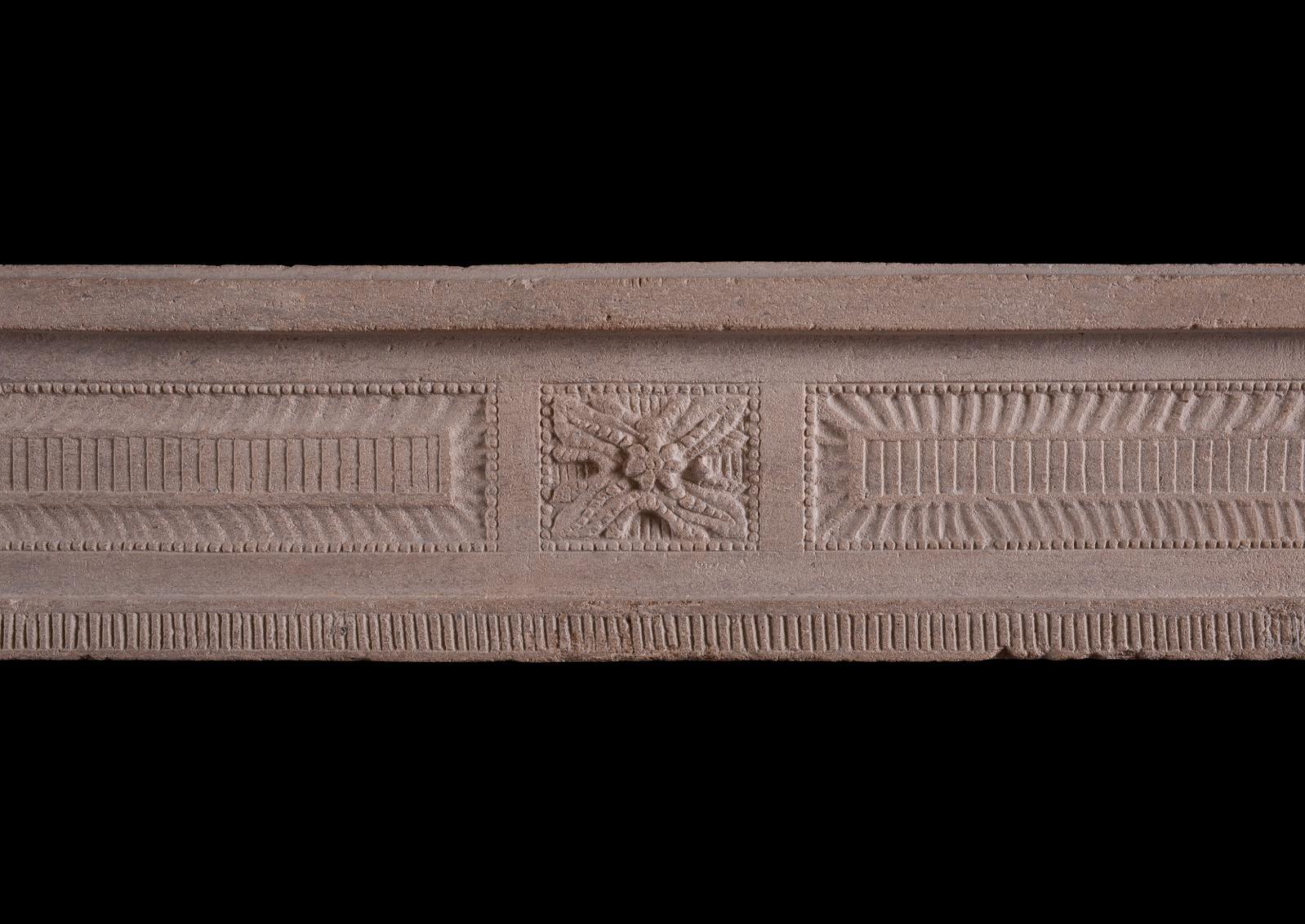 A good quality French limestone Louis XVI fireplace of small scale. The jambs with tapering raised-and-fielded panels and beading, the frieze with carved paterae featuring foliage and beading, with fluting between. French, period.


Shelf Width: