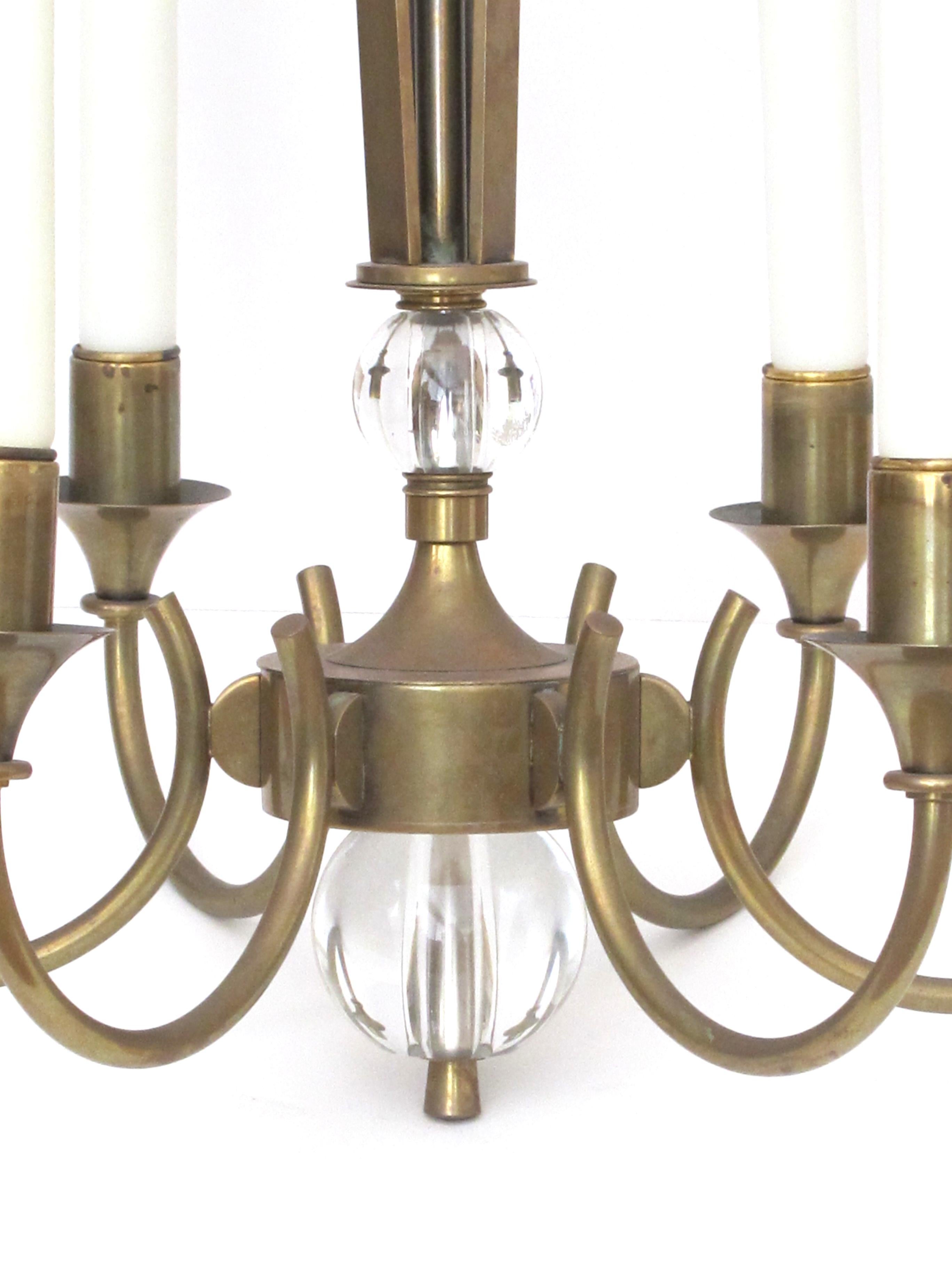 A good quality and stylish French midcentury brass 6-arm chandelier fitted with glass orbs; the tapering openwork support above 6 scrolled arms ending in glass orb pendant knob.
