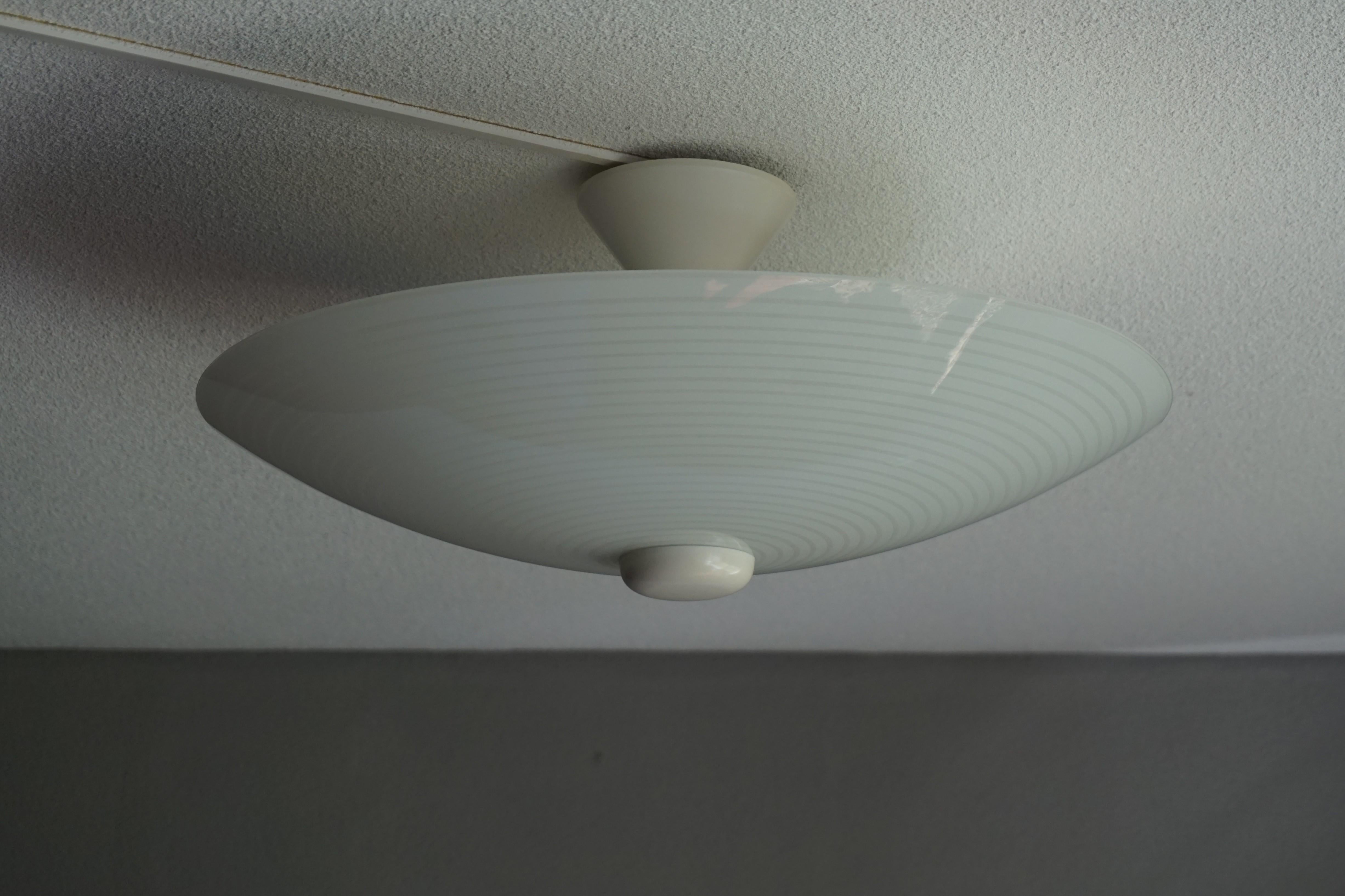 Very stylish Mid-Century Modern, grey and white circular pattern ceiling lamp.

This vintage light fixture has a beautiful look and feel and you will hardly ever find a light fixture from the Mid-Century Modern era with a more timeless glass shade.