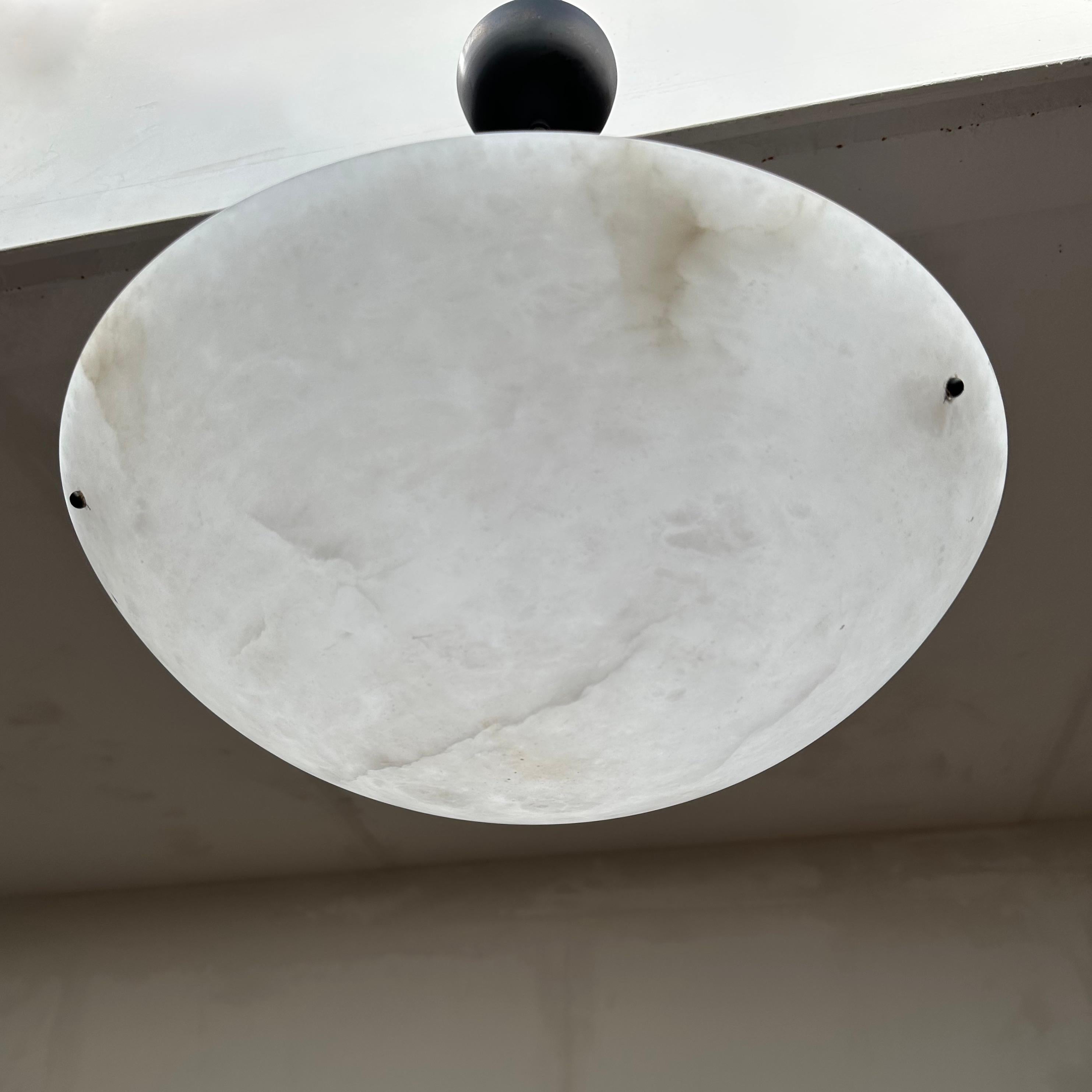 Stylish and pure white alabaster pendant light.

This rare and good size alabaster light fixture also is of a beautiful design. The clean and perfectly polished surface of this alabaster shade comes with lunar like patterns which makes this timeless
