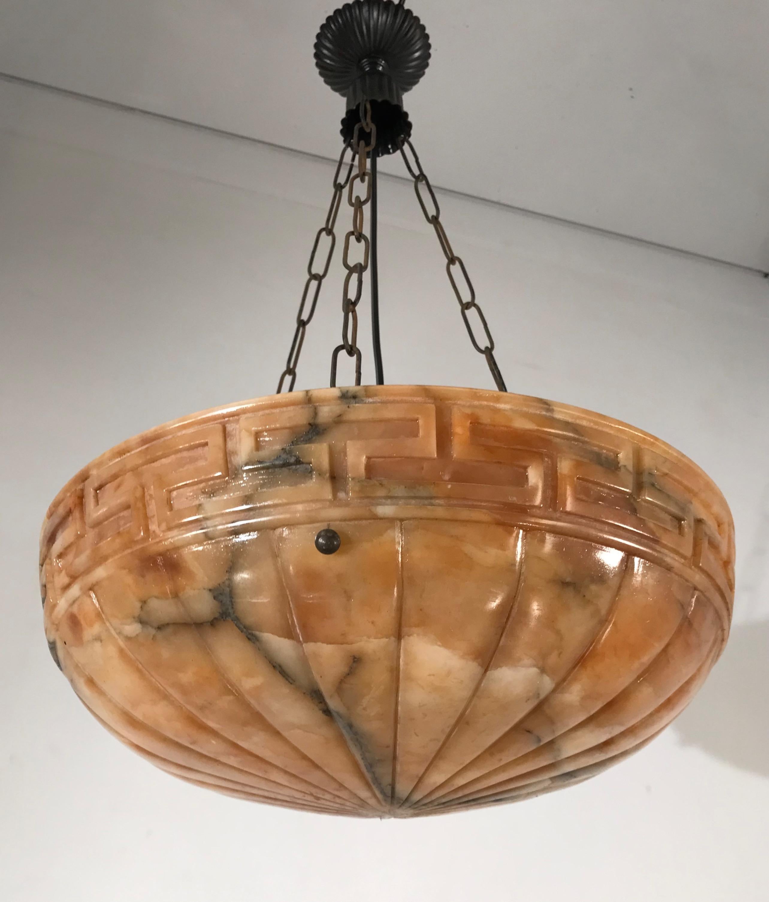 Beautiful design and wonderful light creating, mineral stone pendant.

This marvelous, early 20th century alabaster pendant is hanging from a perfect chain and canopy. The shape, the color and the effect of the beautifully flowing black veins in the