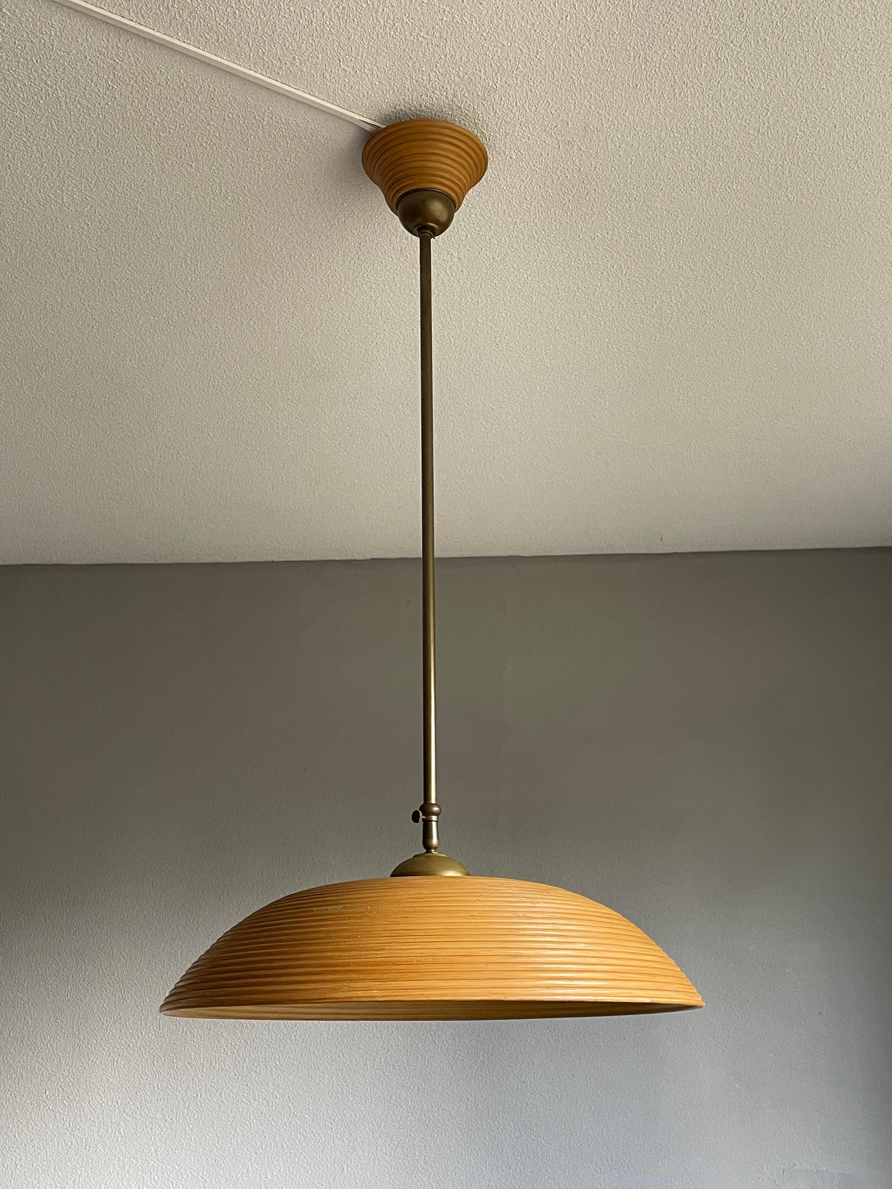 Stylish pair of height adjustable midcentury pendants.

This rare pair of 1970s pendants are perfect for bringing light to your Midcentury kitchen area, your hallway, your living room, your writing table etc. They are made of beautifully shaped,