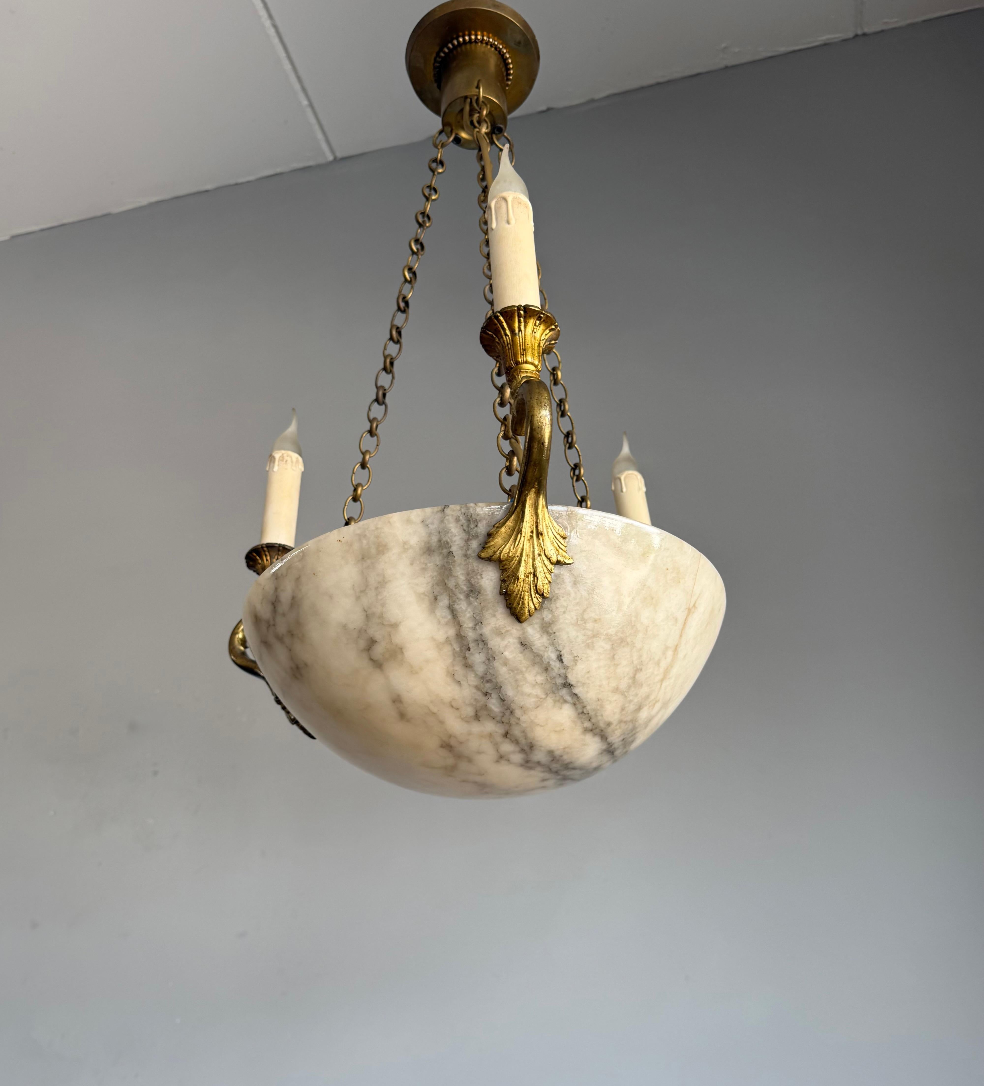 A fine and highly decorative alabaster pendant light from the early 1900s.

With early 20th century lighting as one of our specialities, finding highly attractive antique fixtures in very good condition always makes our day. This antique pendant has