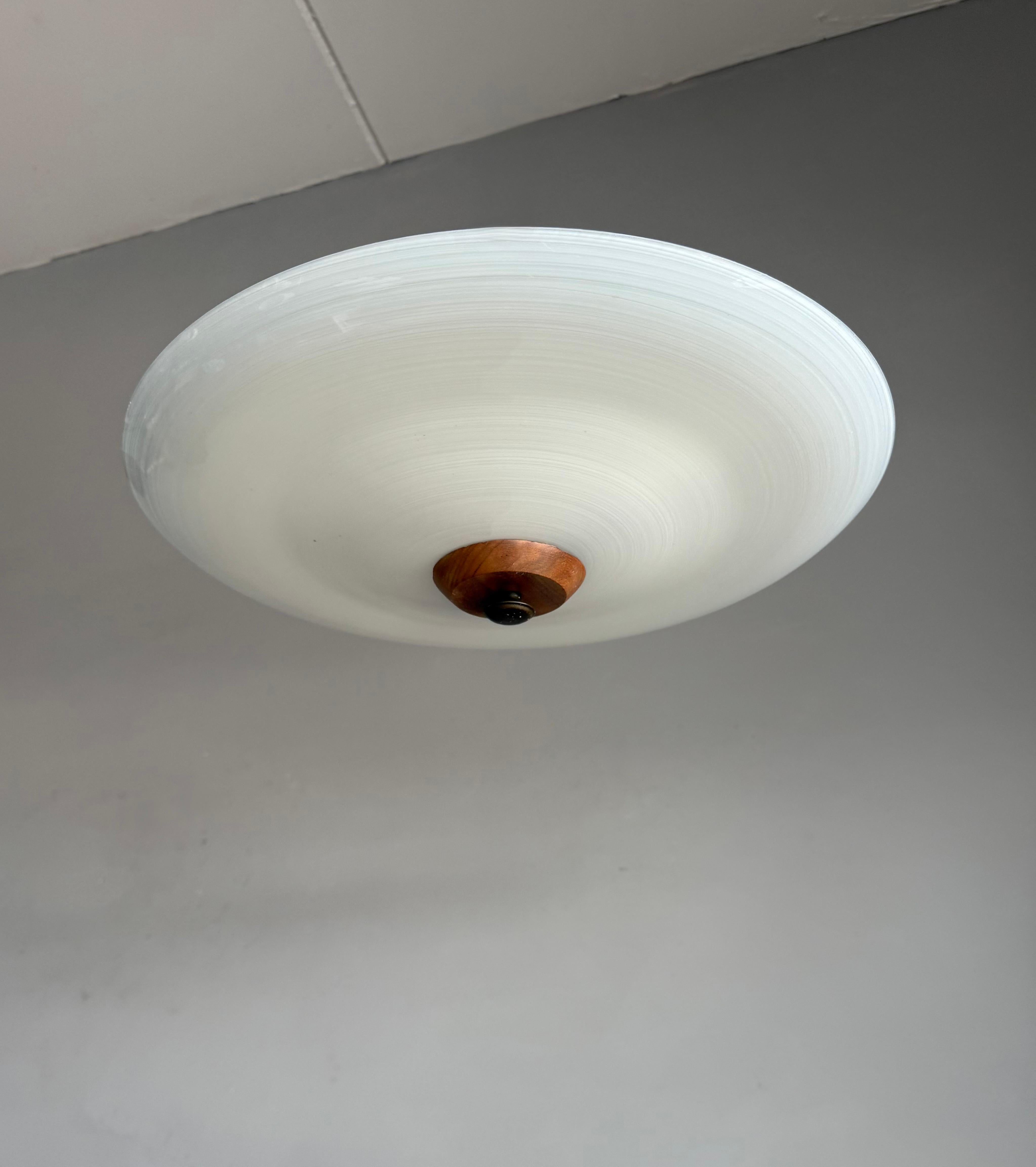 Very stylish Mid-Century Modern, 'swirling' circular pattern ceiling lamp.

This vintage light fixture has a beautiful look and feel and you will hardly ever find a light fixture from the Mid-Century Modern era with a more timeless glass shade. The