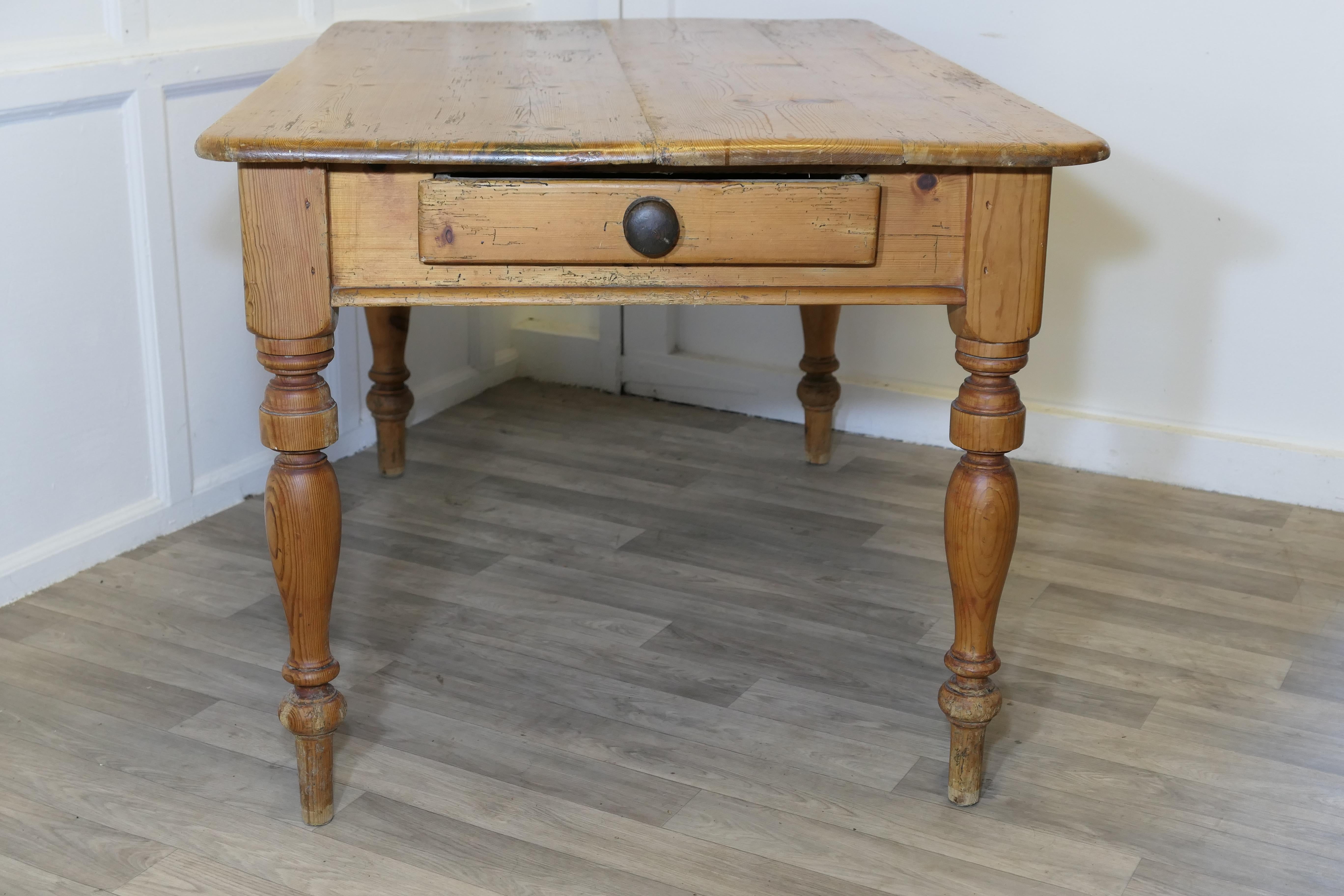 Good Sturdy Pine Farmhouse Kitchen Table

A good Farmhouse table, the 4 plank top is made in solid pine, it has a large drawer and attractive turned legs.
The table is very strong and sturdy with some signs of character and use  
This is an