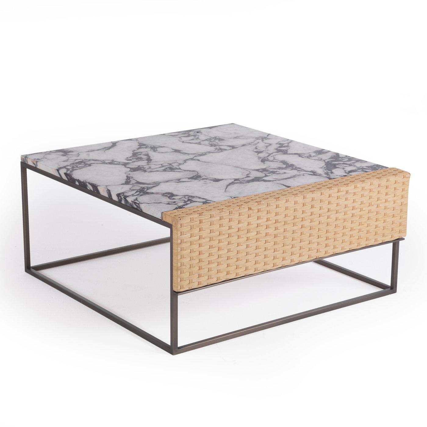 This coffee table is a statement piece that combines unique, refined materials into a modern and versatile design. The cubic structure is made of brushed brass and features a splendid top in purple Calacatta marble showcasing natural veins and