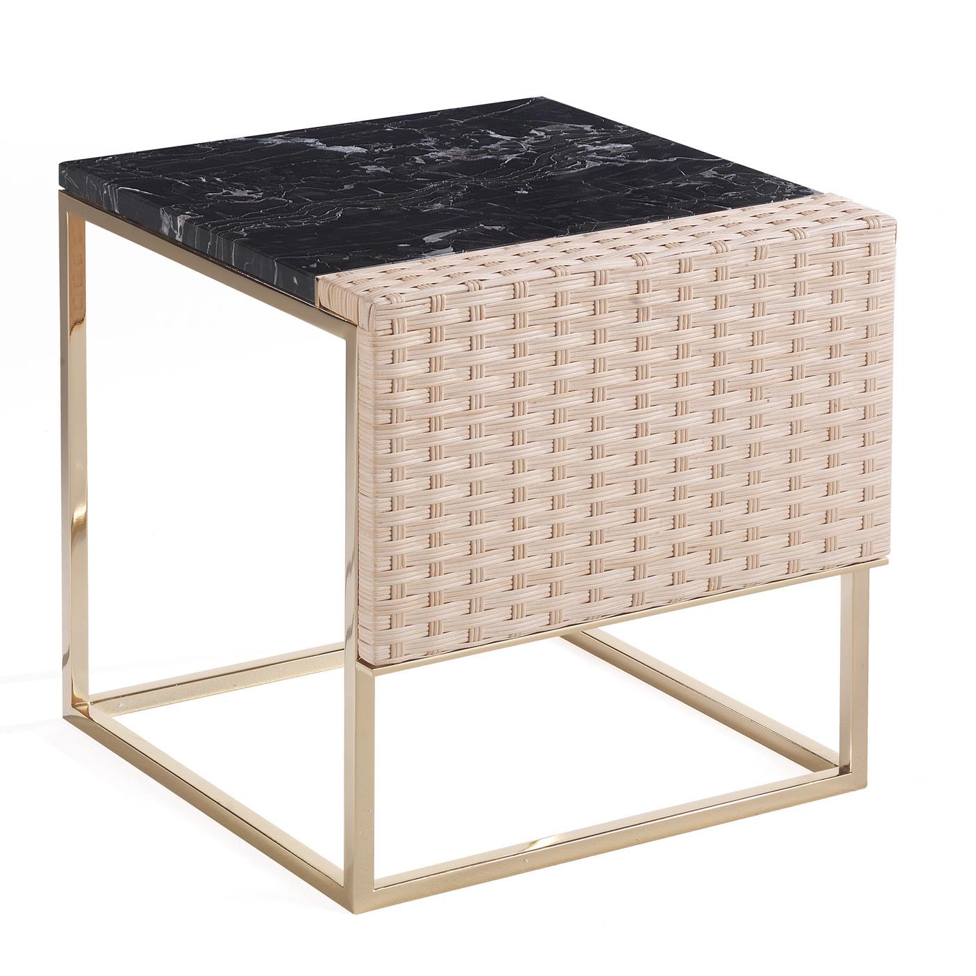 An eclectic and versatile piece of functional decor, this small side table will elevate the look of any home or office decor. It is composed of a cubic brushed brass structure on which lays a splendid top in black Portoro marble and a masterfully