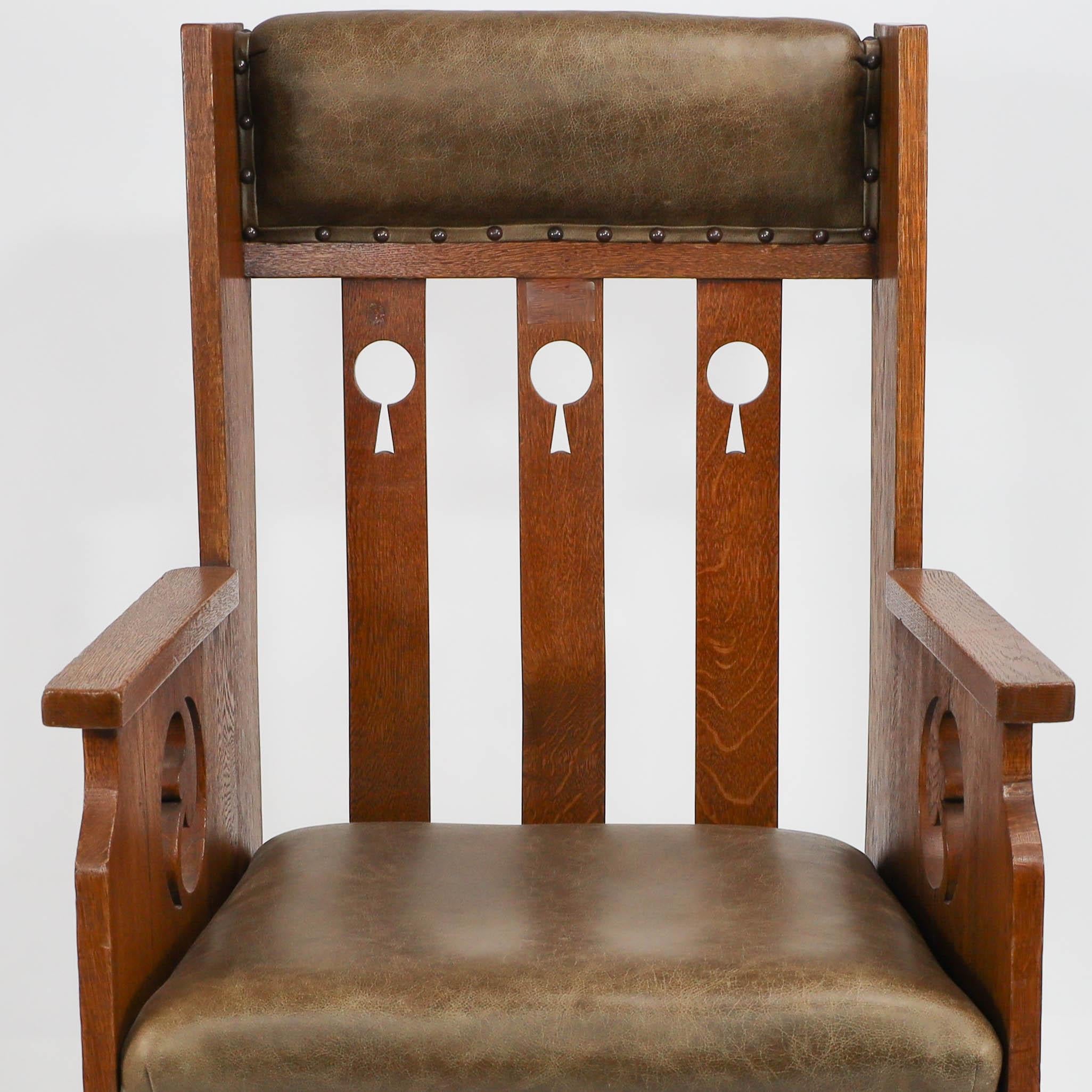Goodyers of Regent St. An Arts & Crafts oak armchair with stylized decoration In Good Condition For Sale In London, GB