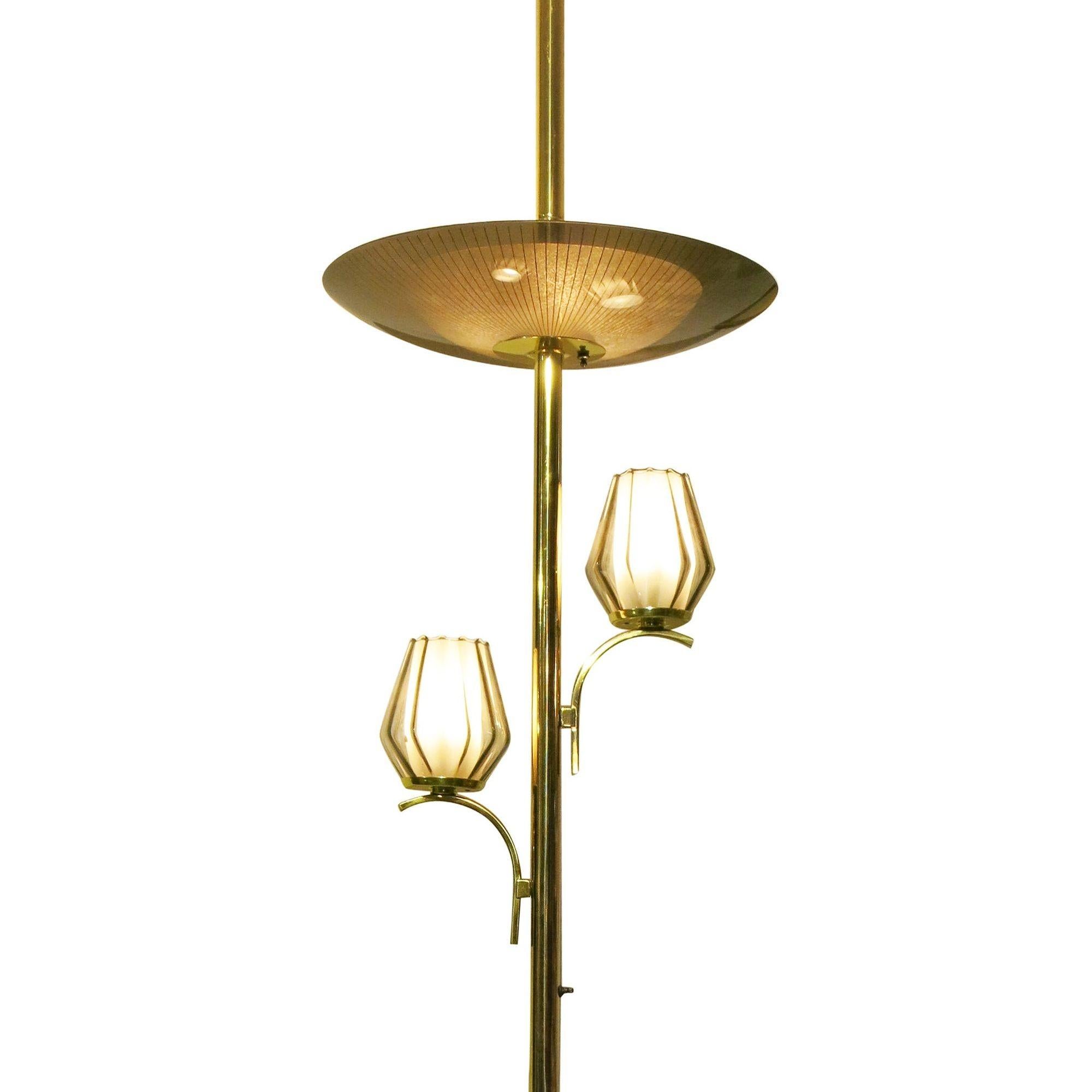 Mid-century brass triple light floor-to-ceiling tension pole lamp with a heavy Googie style. This lamp features a unique tension pole lamp with an adjustable brass pole that is adjustable to the size of your ceiling (95