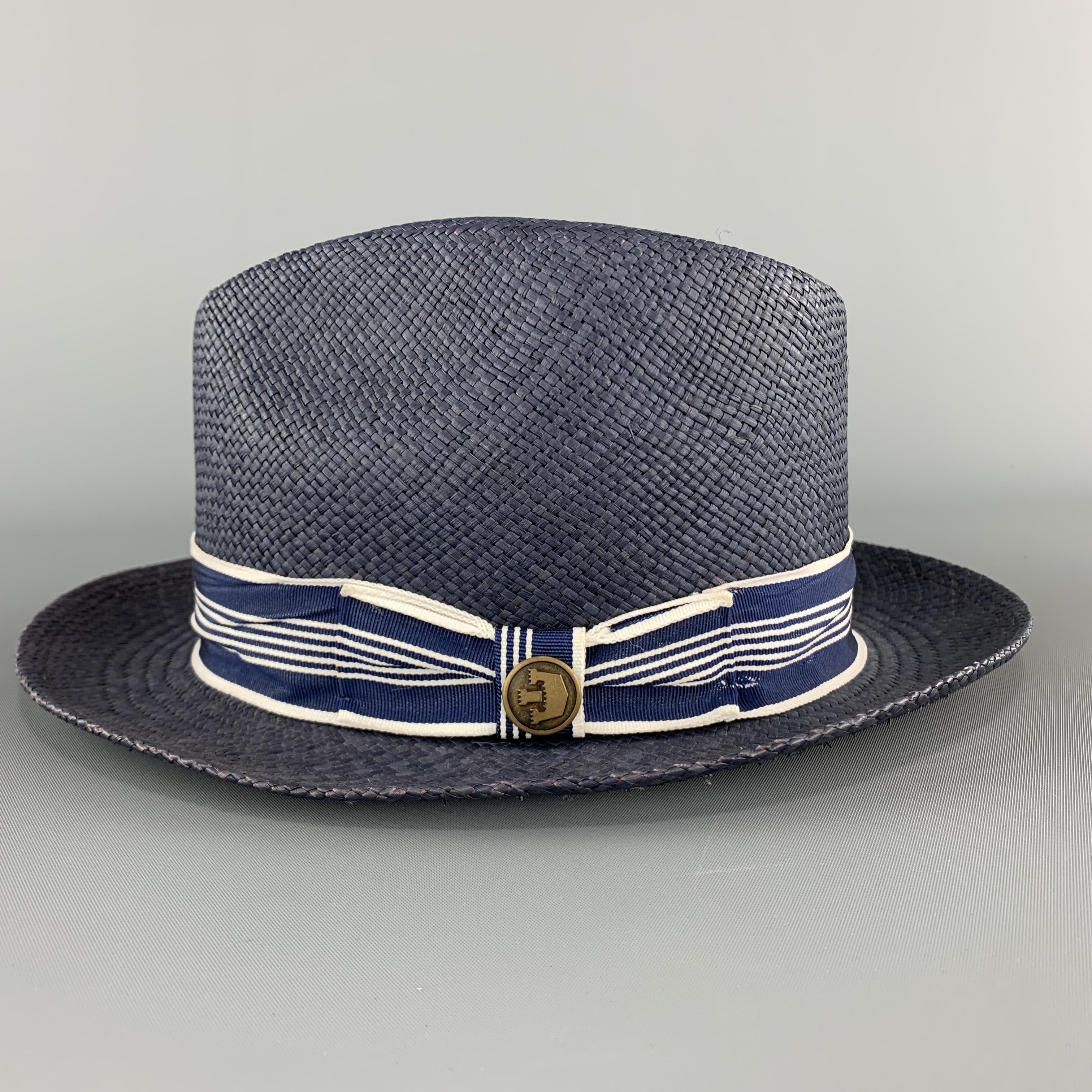 GOORIN BROTHERS fedora comes in navy woven straw with a striped ribbon trim. 

Excellent Pre-Owned Condition.
Marked: Small

Measurements:

Opening: 22.5 in.
Brim: 2 in.
Height: 4.25 in.
