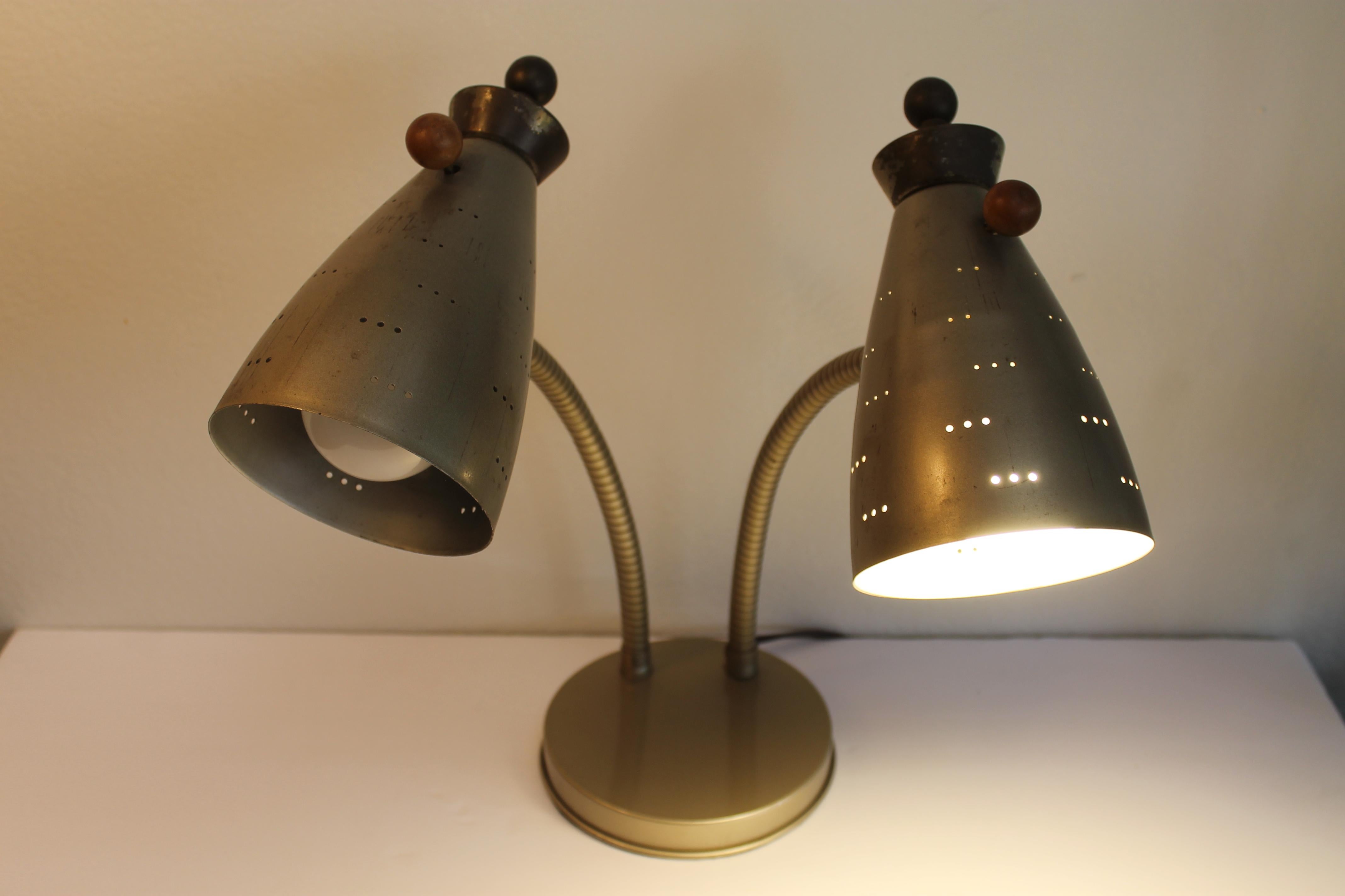 Goose neck table lamp with original patina. This fixture was originally a wall sconce. We replaced the inside weight with a heavier version and professionally rewired it for a table lamp with 3-way light bulbs. Lamp measures (as photographed) 14